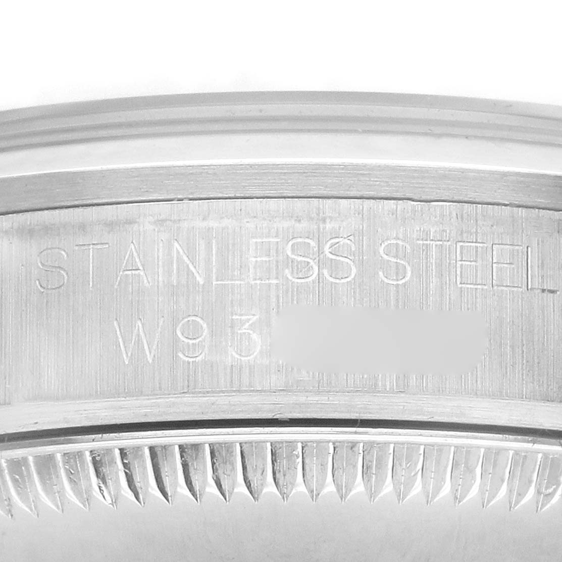 The image shows a close-up of the case side engraving of a Rolex Oyster Perpetual 67480 Women's Stainless Steel White Dial, highlighting the stainless steel marking.