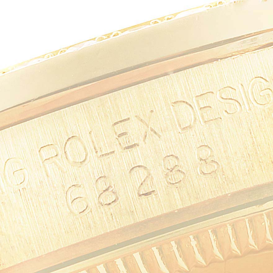 This close-up image shows the engraved side of the case of a Rolex President 68288 Women
s Yellow Gold Champagne Dial 68288 Women
s Yellow Gold Champagne Dial watch.