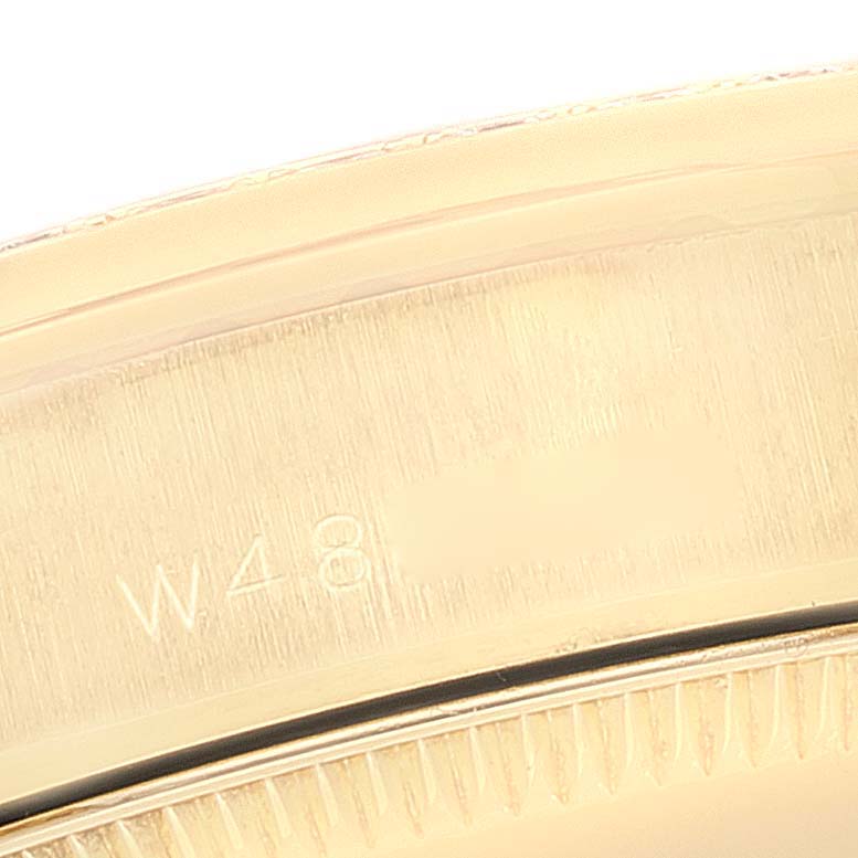 The image shows a close-up of the inner bezel with engravings on a Rolex President 68288 Women
s Yellow Gold Champagne Dial 68288 Women
s Yellow Gold Champagne Dial model watch.