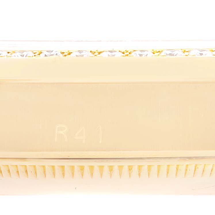 This close-up image is of the side of a Rolex President 68288 Women's Yellow Gold Champagne Dial 68288 Women's Yellow Gold Champagne Dial model, showcasing part of the watch case and bezel.