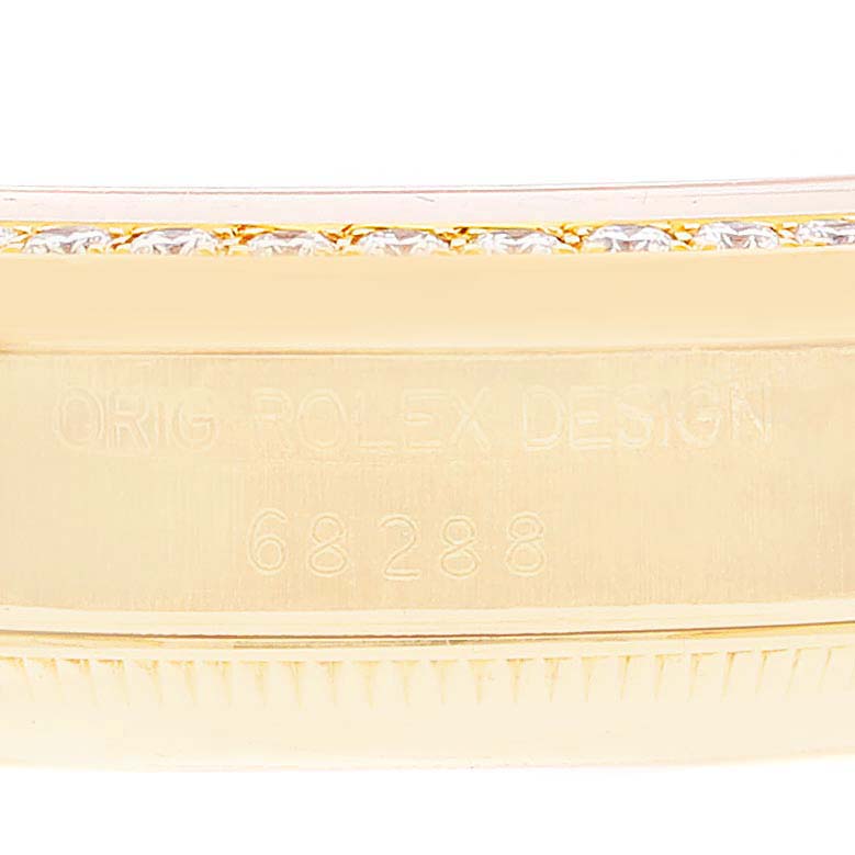 This close-up image shows the engraved side of a Rolex President 68288 Women's Yellow Gold Champagne Dial 68288 Women's Yellow Gold Champagne Dial model watch case, featuring its design and serial number.