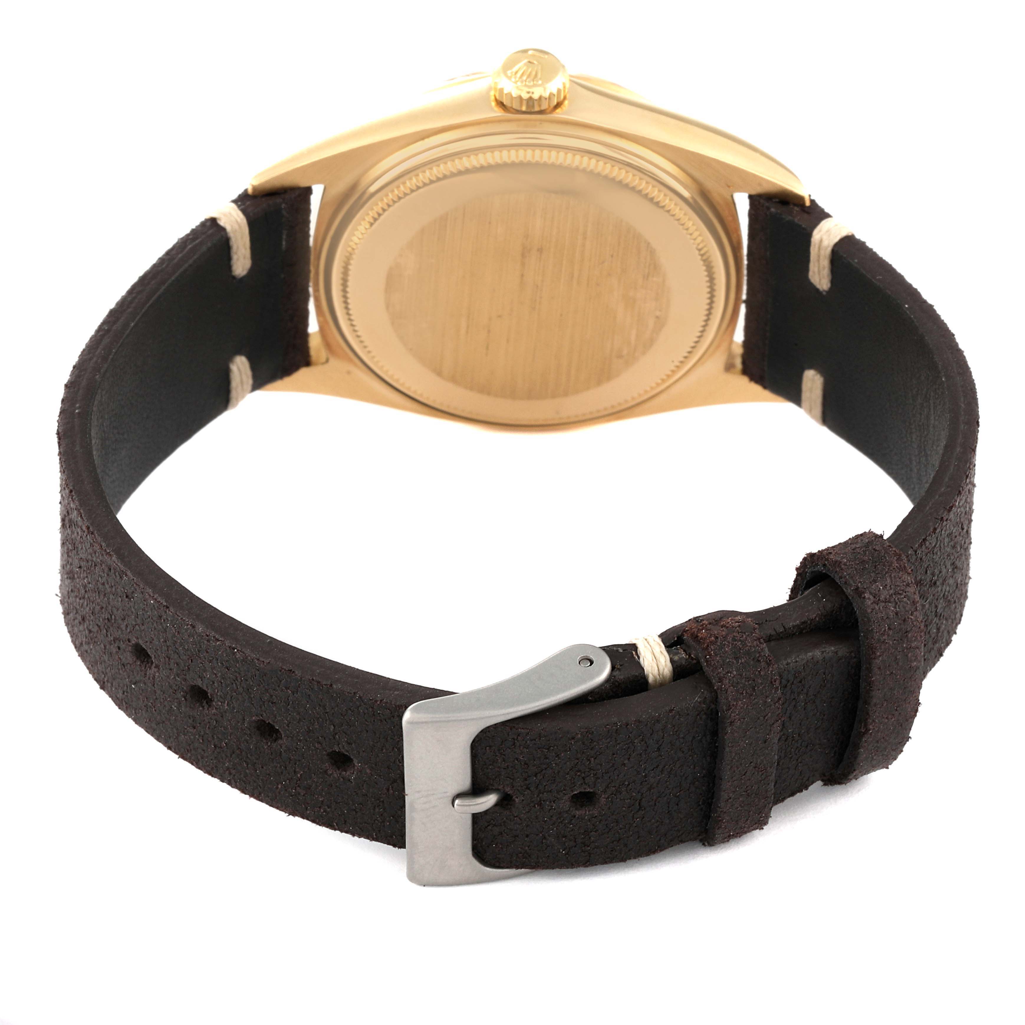 This image shows the back view of a Vintage Collection Rolex watch, highlighting its case, crown, and leather strap with buckle.