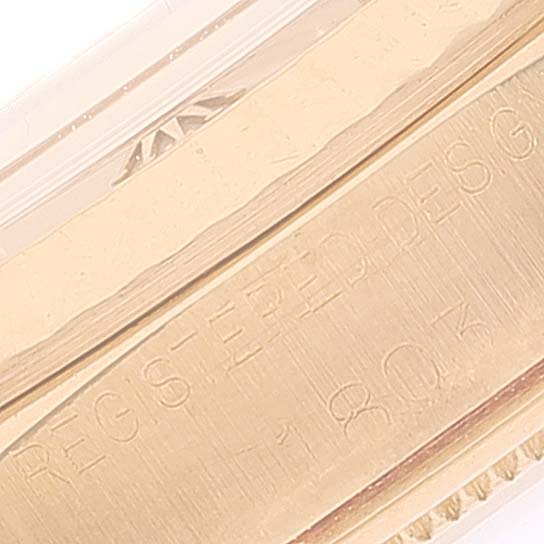 This image shows a close-up of the Rolex Vintage Collection 1803 Men's Yellow Gold Silver Dial 1803 Men's Yellow Gold Silver Dial model's engraved serial number and part of the band.