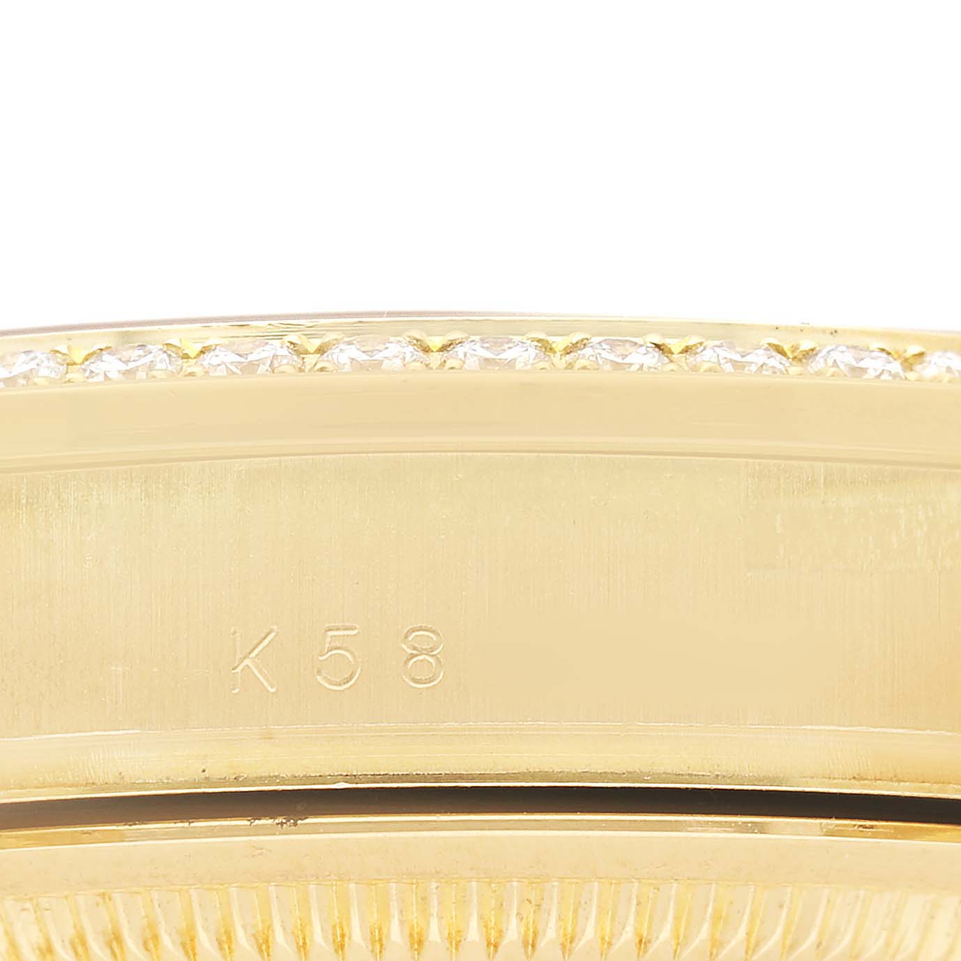 The image shows a close-up of the side profile of a Rolex President 118348 Men's Yellow Gold Champagne Dial watch, highlighting the bezel with diamonds and engravings.