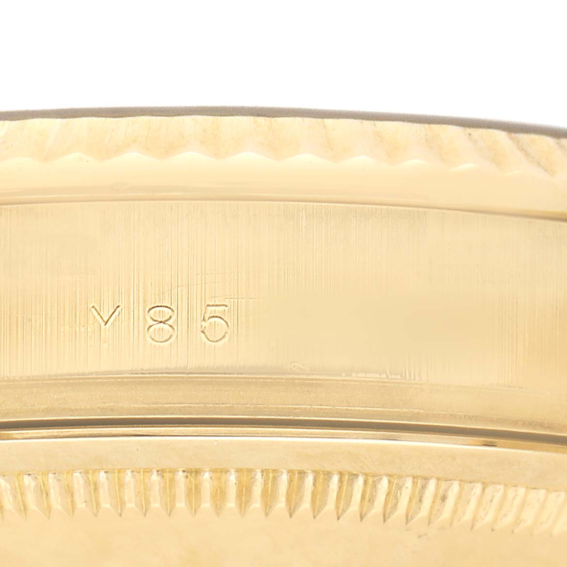 This image shows a close-up of the gold bezel and side engraving of the Rolex President 118238 Men's Yellow Gold Champagne Dial watch.