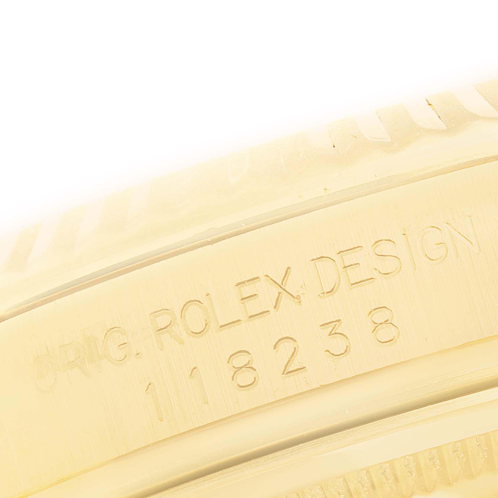 The image shows a close-up of the engraved case side of the Rolex President 118238 Men's Yellow Gold Champagne Dial model, highlighting the design and serial numbers.