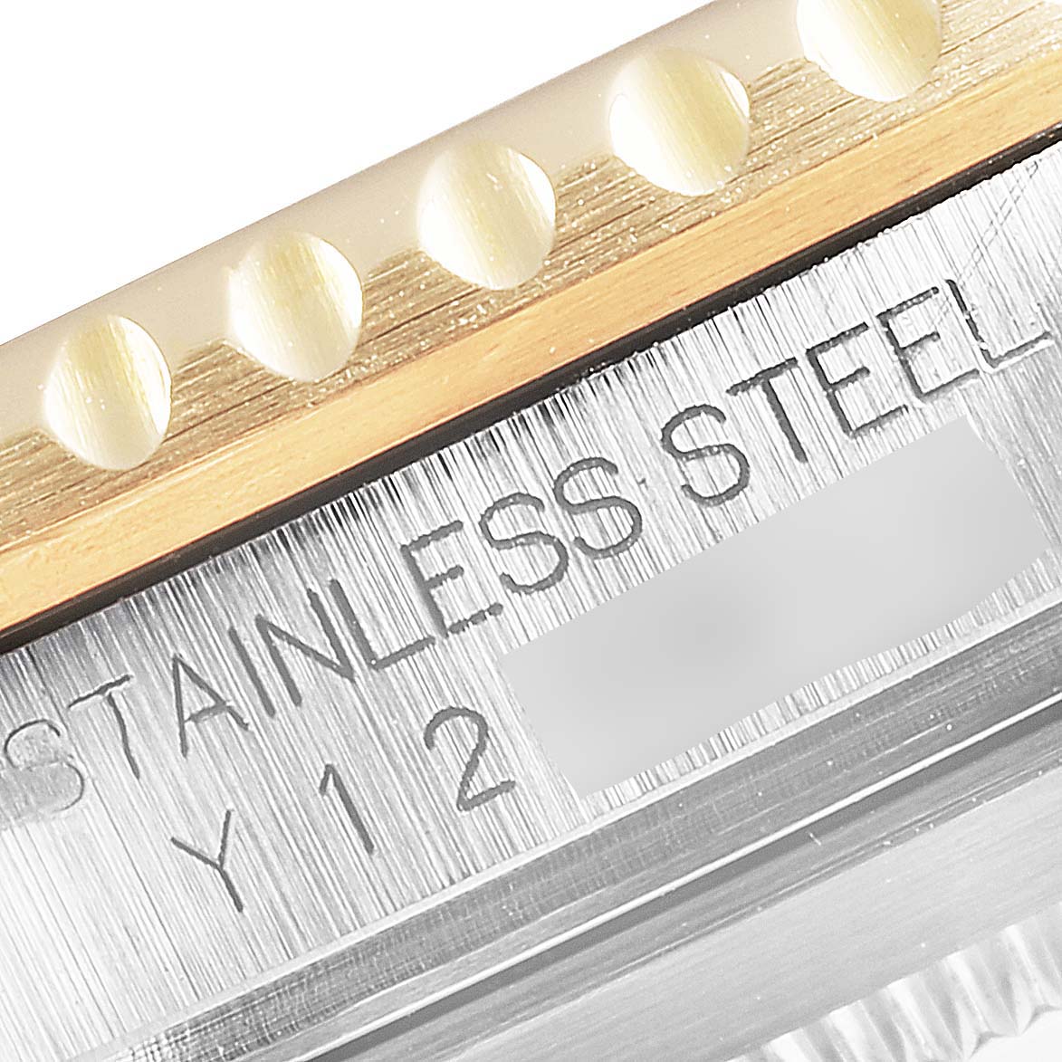 Close-up of a Rolex Submariner 16613 Men
s Steel and Gold (two tone) Black Dial 16613 Men
s Steel and Gold (two tone) Black Dial, showcasing the stainless steel engraving on the case and part of the bezel.