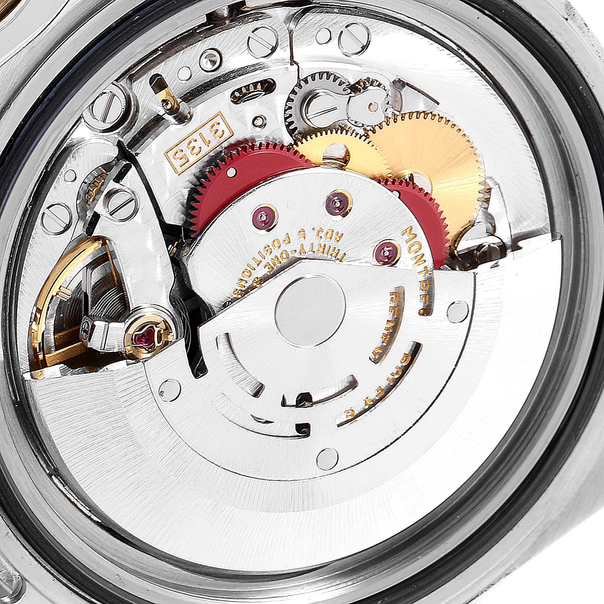 The image shows a close-up of the internal mechanics of a Rolex Submariner 16613 Men
s Steel and Gold (two tone) Black Dial 16613 Men
s Steel and Gold (two tone) Black Dial watch, focusing on its intricate gears and components.