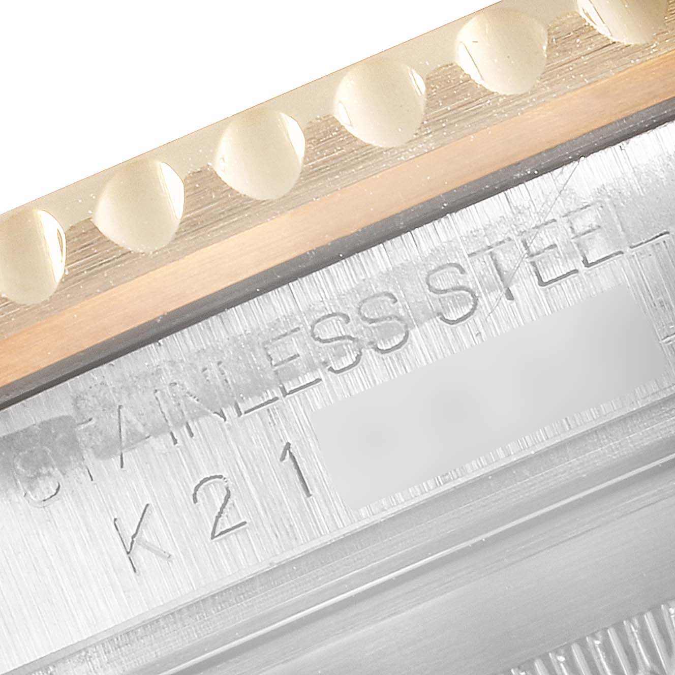 Close-up of the bezel and engraved text on a Rolex Submariner 16613 Men
s Steel and Gold (two tone) Black Dial 16613 Men
s Steel and Gold (two tone) Black Dial watch case.