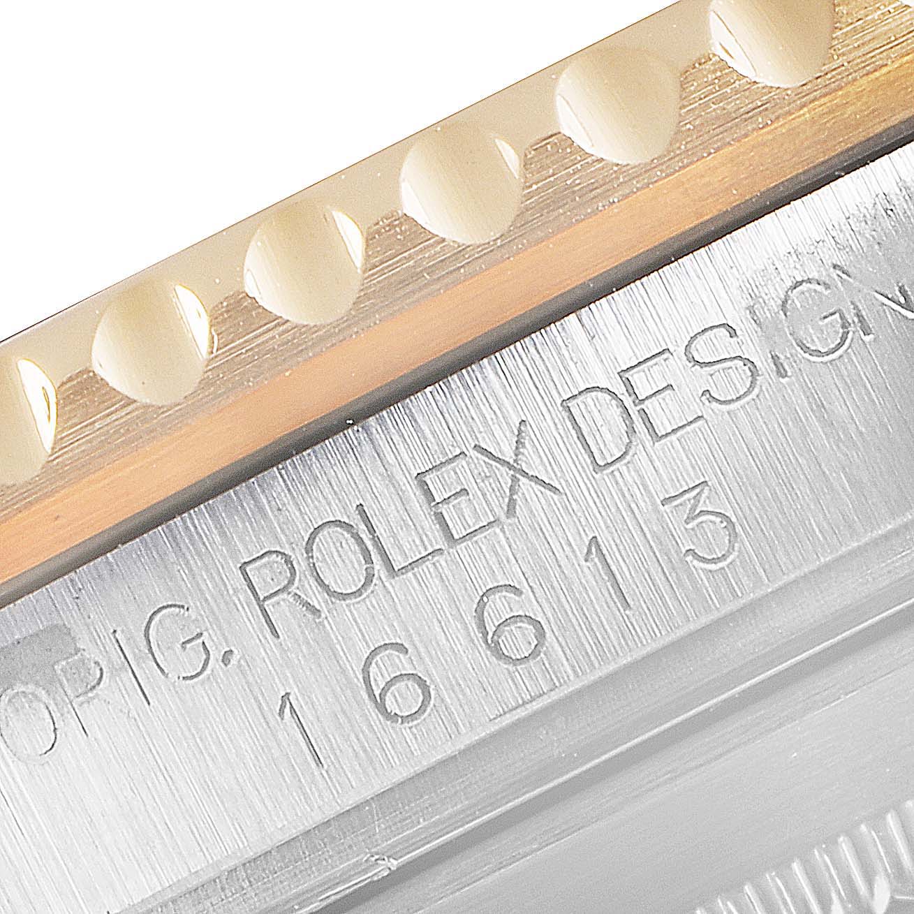 This close-up image shows the engraved model number on the side case of a Rolex Submariner 16613 Men
s Steel and Gold (two tone) Black Dial 16613 Men
s Steel and Gold (two tone) Black Dial.