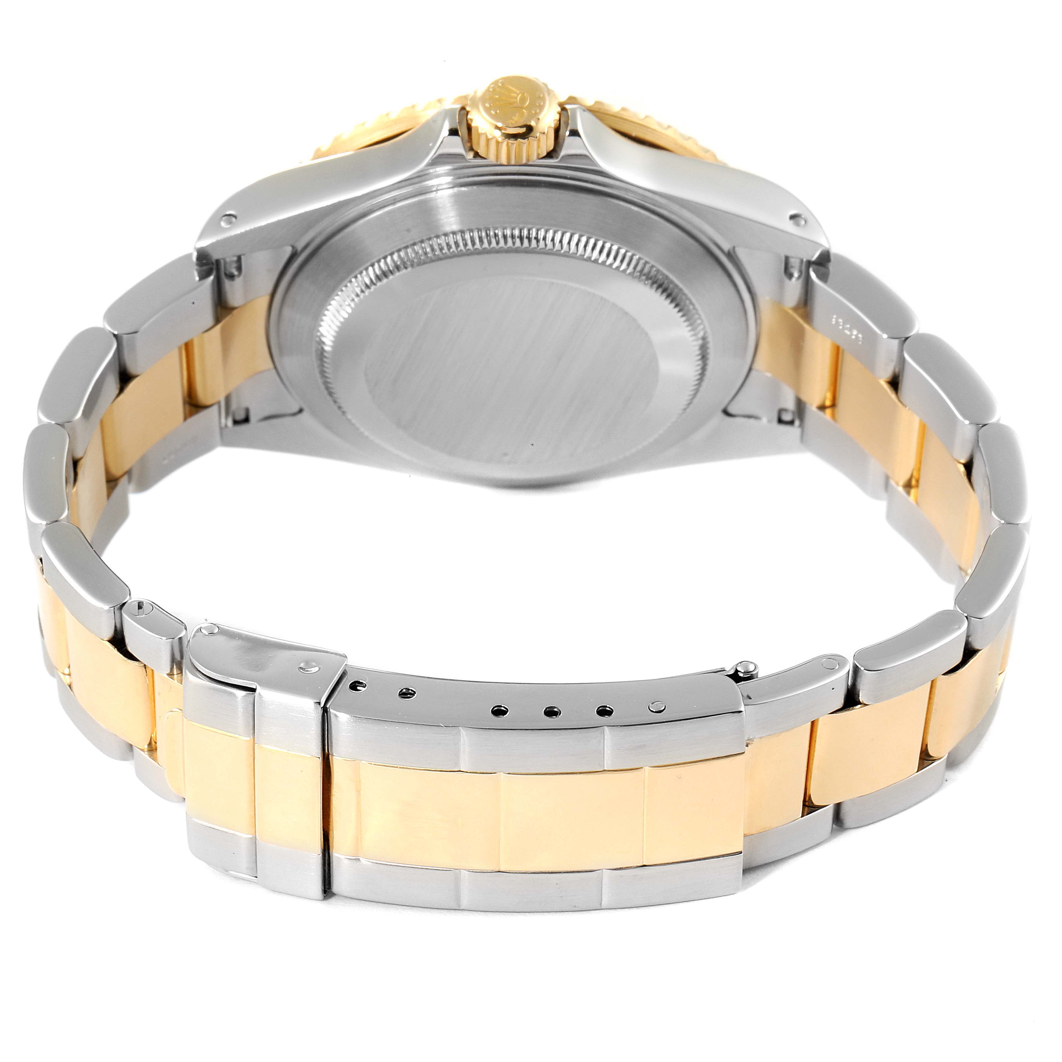 The image shows the back view of a Rolex Submariner 16613 Men's Steel and Gold (two tone) Blue Dial 16613 Men's Steel and Gold (two tone) Blue Dial, highlighting the case back, crown, and two-tone bracelet.