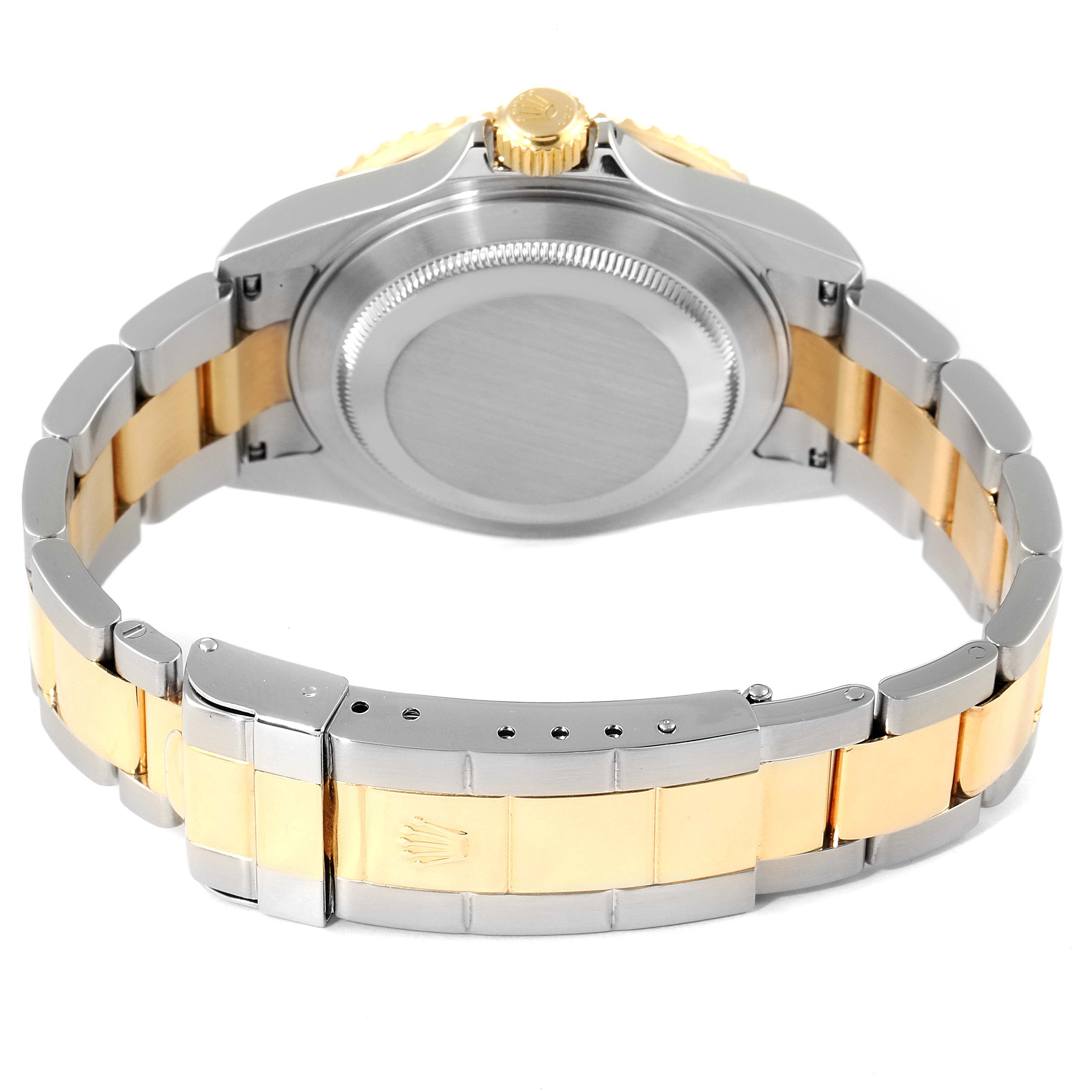 The image shows the back of a Rolex Submariner 16613 Men
s Steel and Gold (two tone) Blue Dial 16613 Men
s Steel and Gold (two tone) Blue Dial watch, highlighting the case back and the two-tone metal bracelet with clasp.