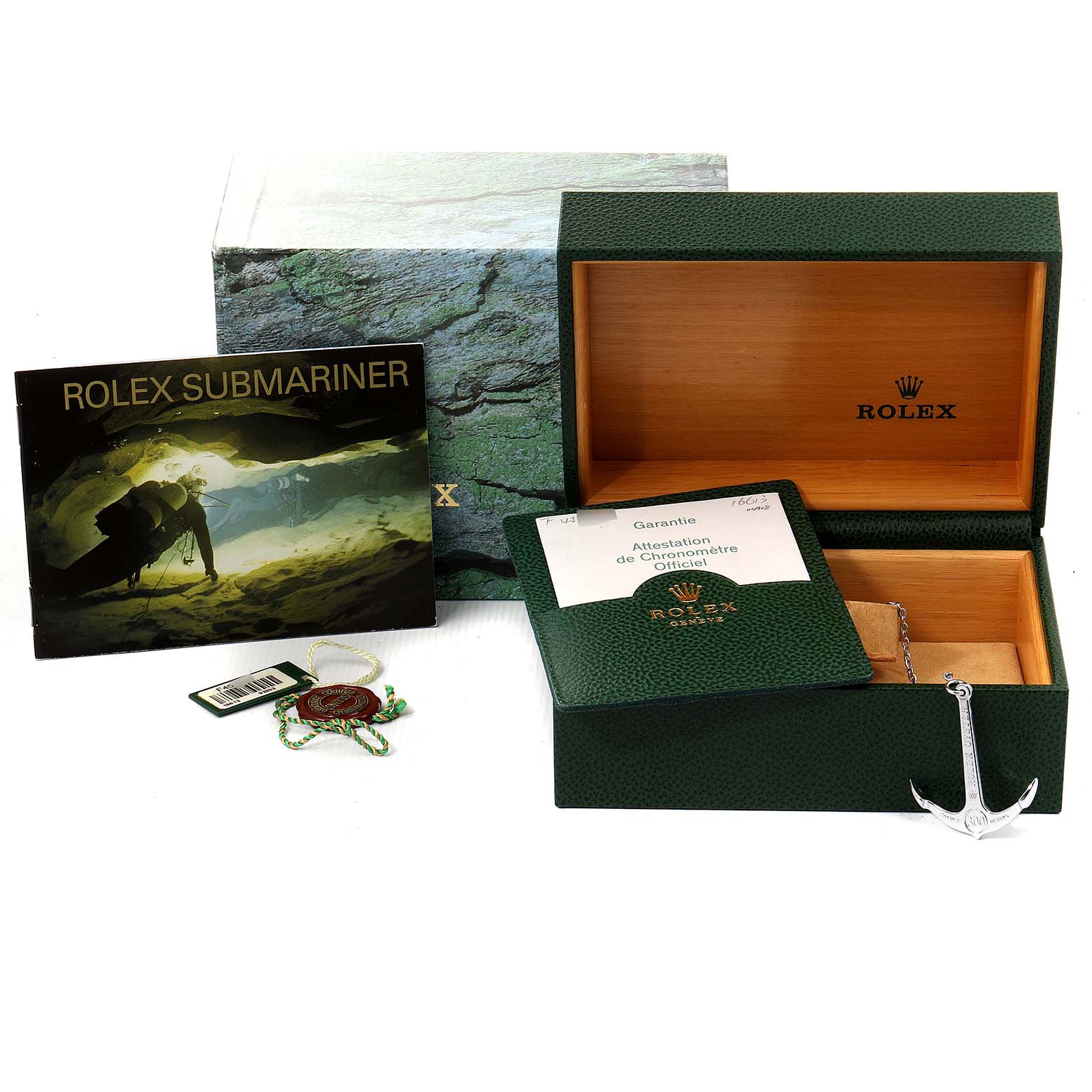 This image shows the packaging, warranty card, manual, and accessories for a Rolex Submariner 16613 Men
s Steel and Gold (two tone) Blue Dial 16613 Men
s Steel and Gold (two tone) Blue Dial watch.