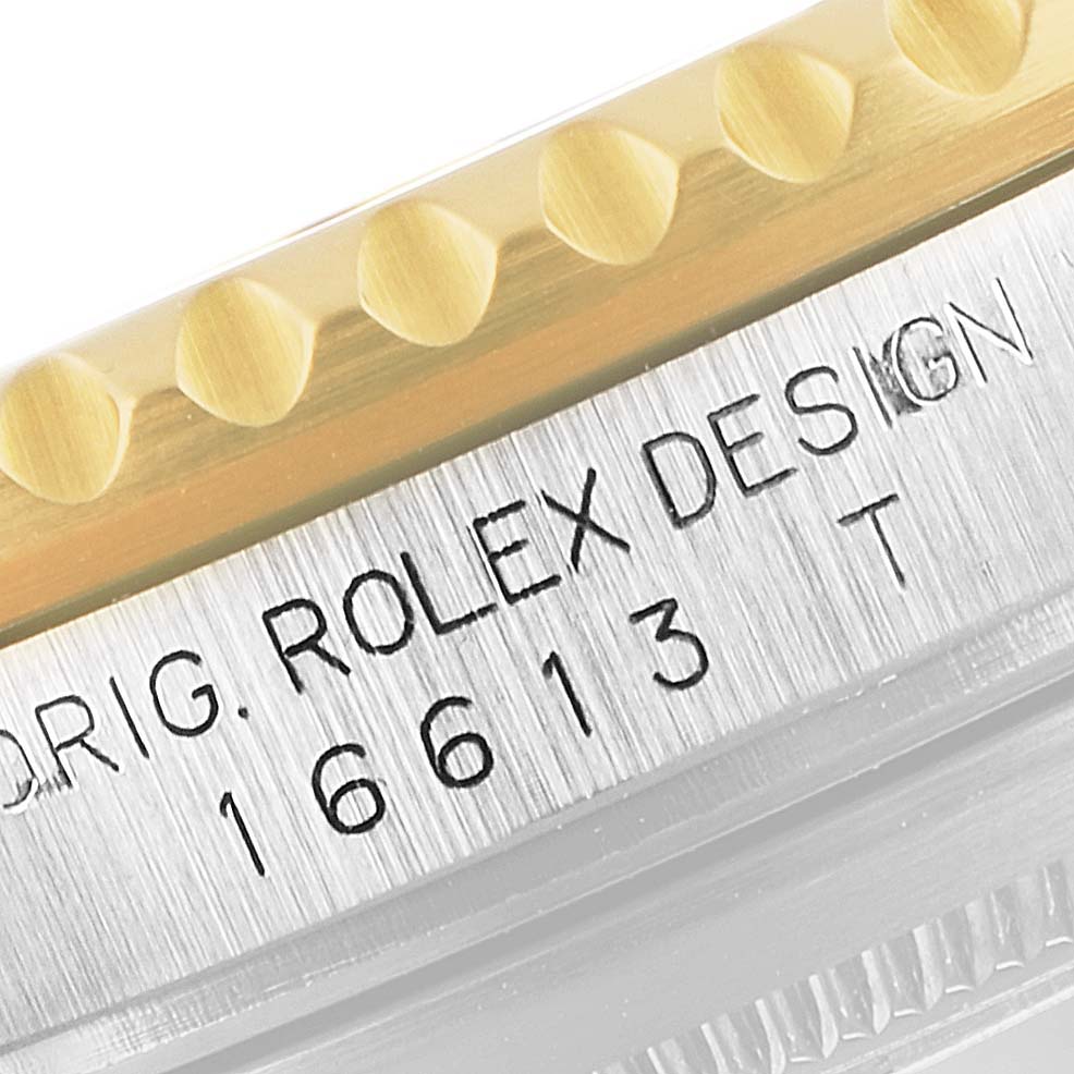 This image shows a close-up of the case side of a Rolex Submariner 16613 Men
s Steel and Gold (two tone) Blue Dial 16613 Men
s Steel and Gold (two tone) Blue Dial, highlighting the model number 16613 and part of the bezel.