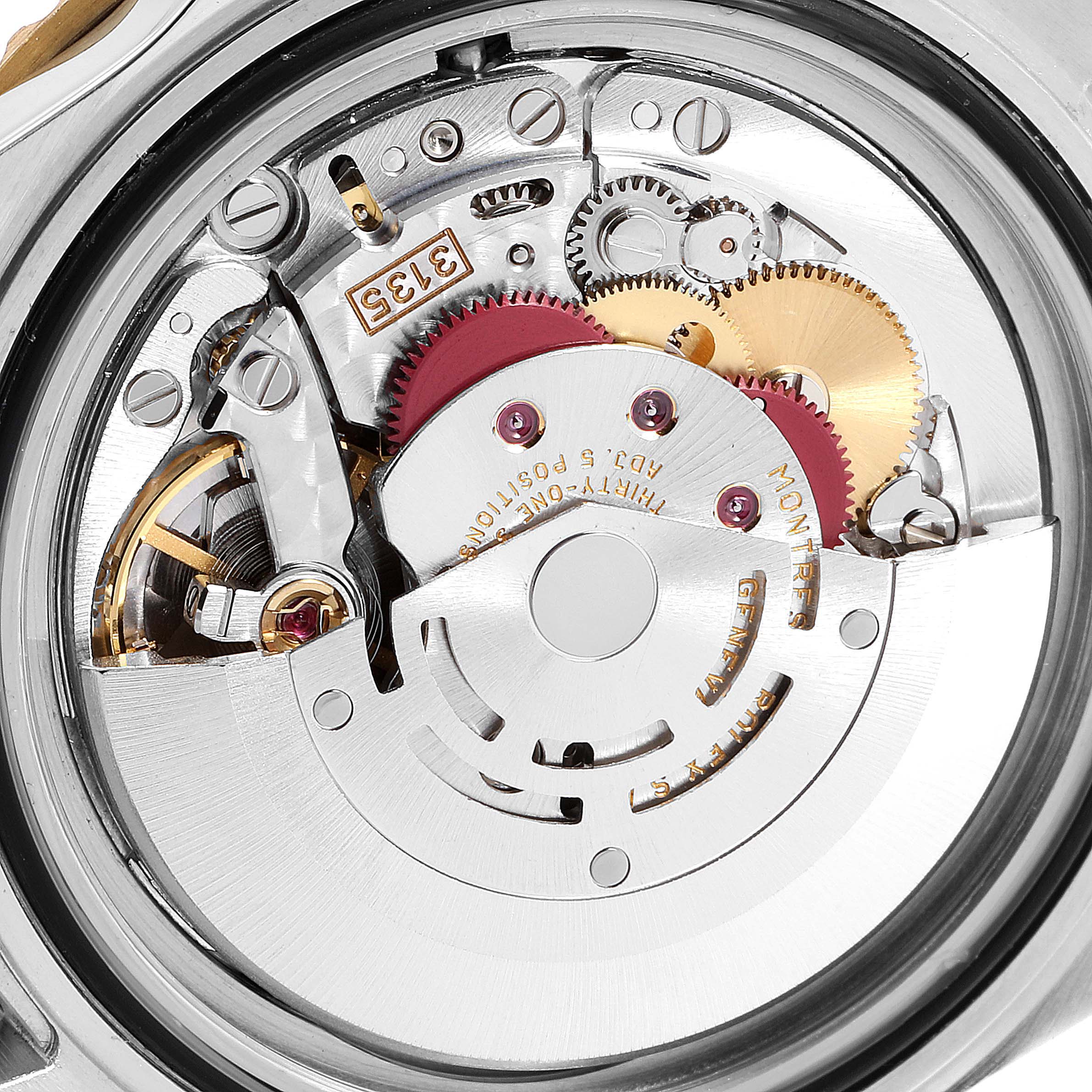This image shows the intricate inner movement mechanism of a Rolex Submariner 16613 Men
s Steel and Gold (two tone) Champagne Dial 16613 Men
s Steel and Gold (two tone) Champagne Dial watch from a rear angle.