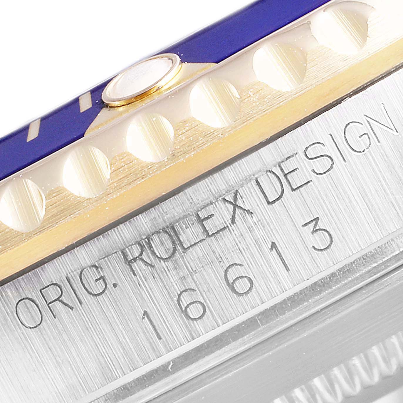 The image shows a close-up of the bezel and case side of a Rolex Submariner 16613 Men
s Steel and Gold (two tone) Champagne Dial 16613 Men
s Steel and Gold (two tone) Champagne Dial model, highlighting its design and model number.