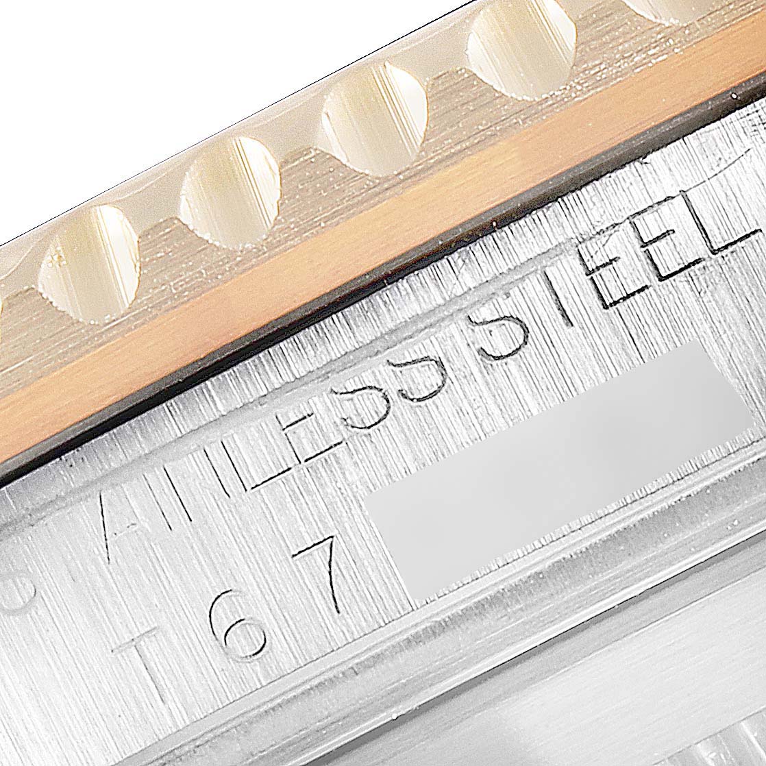 This close-up image shows the stainless steel edge and part of the bezel of a Rolex Submariner 16613 Men
s Steel and Gold (two tone) Champagne Dial 16613 Men
s Steel and Gold (two tone) Champagne Dial watch.