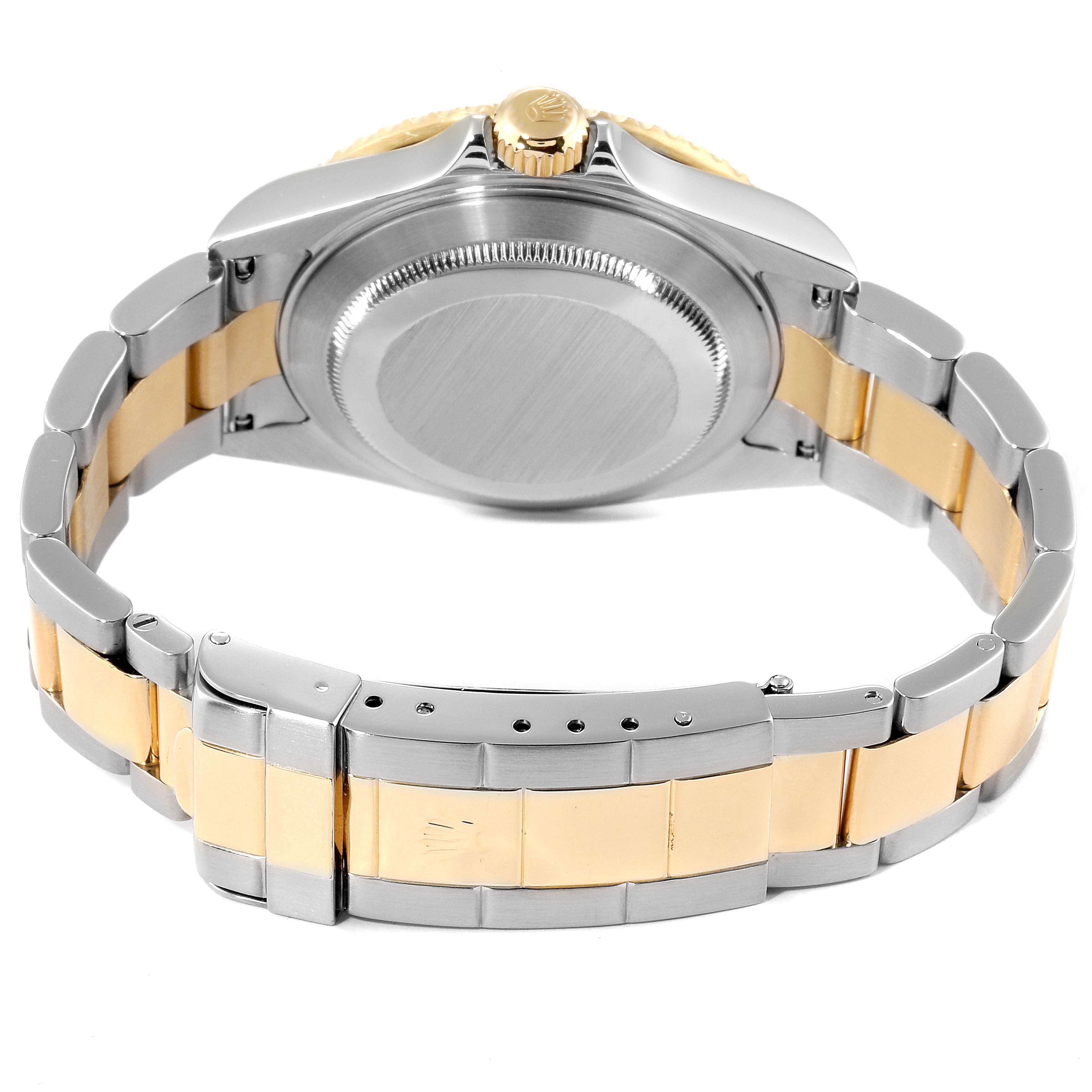 The image shows the back and clasp of a Rolex Submariner 16613 Men's Steel and Gold (two tone) Grey Dial 16613 Men's Steel and Gold (two tone) Grey Dial watch, highlighting the two-tone bracelet and crown.