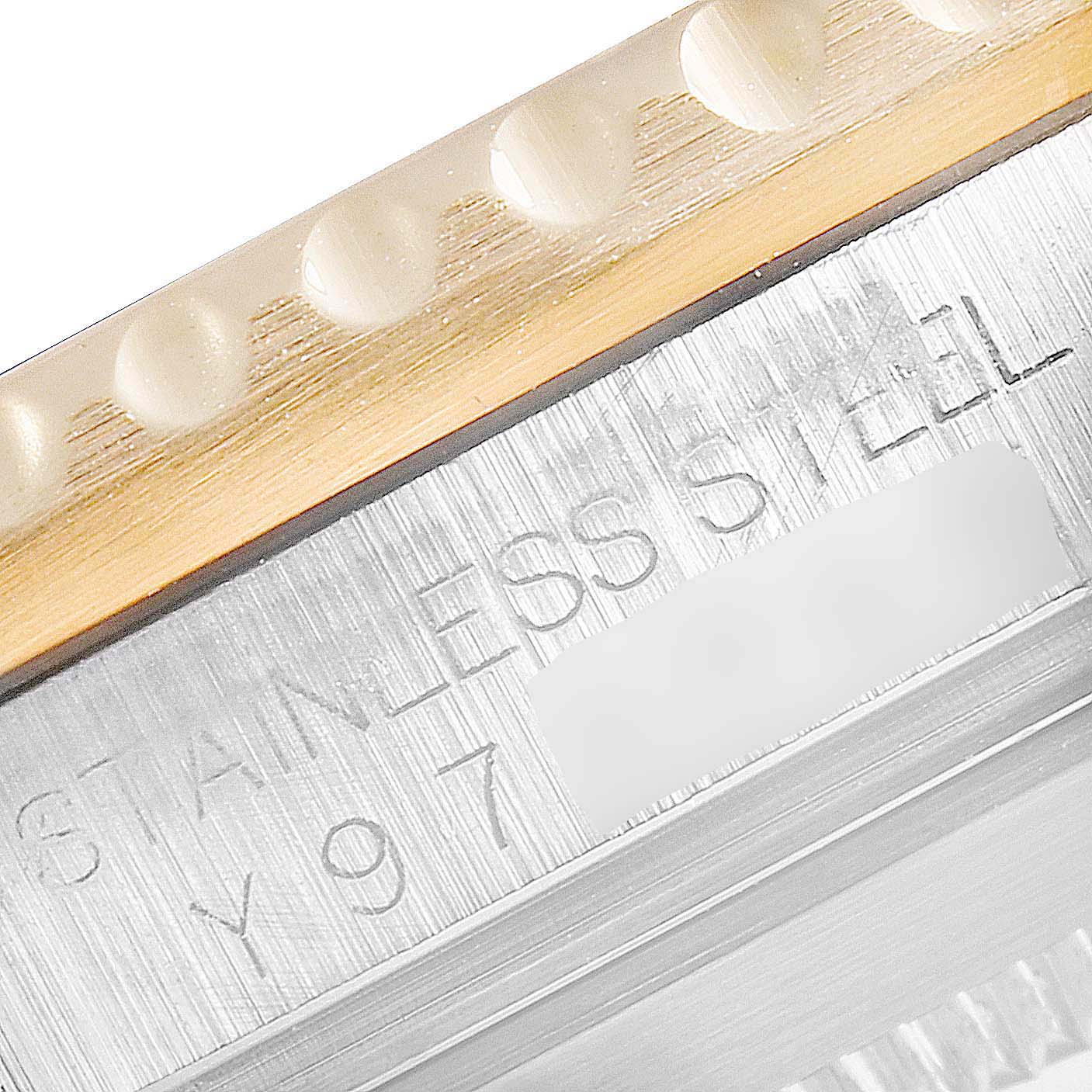 This close-up image of a Rolex Submariner 16613 Men's Steel and Gold (two tone) Grey Dial 16613 Men's Steel and Gold (two tone) Grey Dial shows the side of the stainless steel case with part of the bezel.