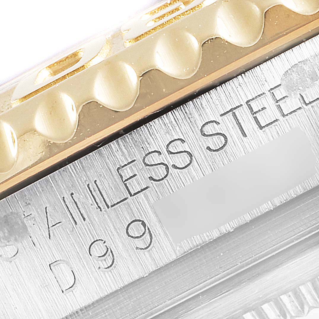 Close-up of the bezel and part of the stainless steel case of a Rolex Yacht-Master 16623 Men's Steel and Gold (two tone) White Dial 16623 Men's Steel and Gold (two tone) White Dial watch.