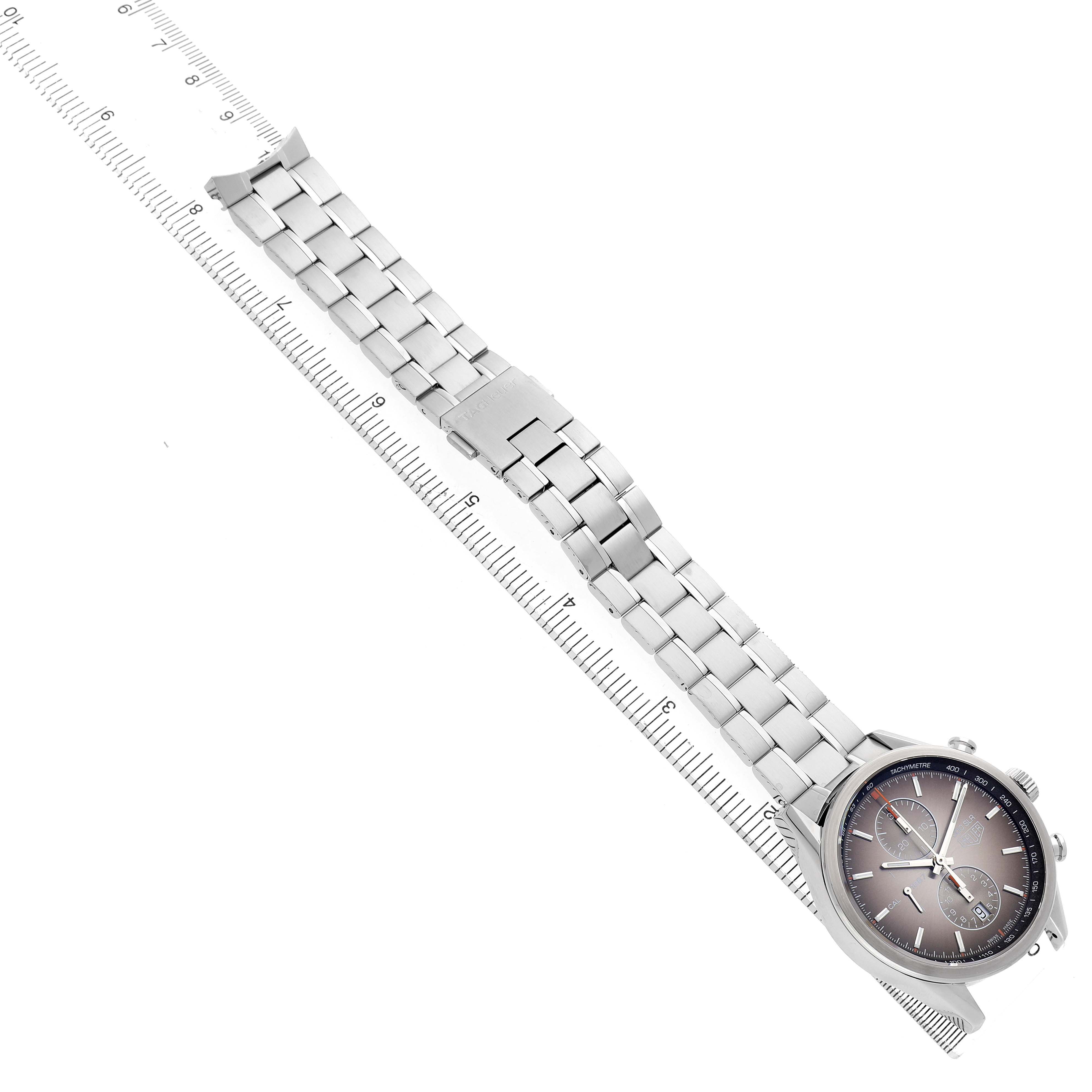 The image shows a Tag Heuer Carrera CAR2112.FC6267 Men's Stainless Steel Brown Dial watch with a steel bracelet laid alongside a ruler, viewed from a top-down angle.
