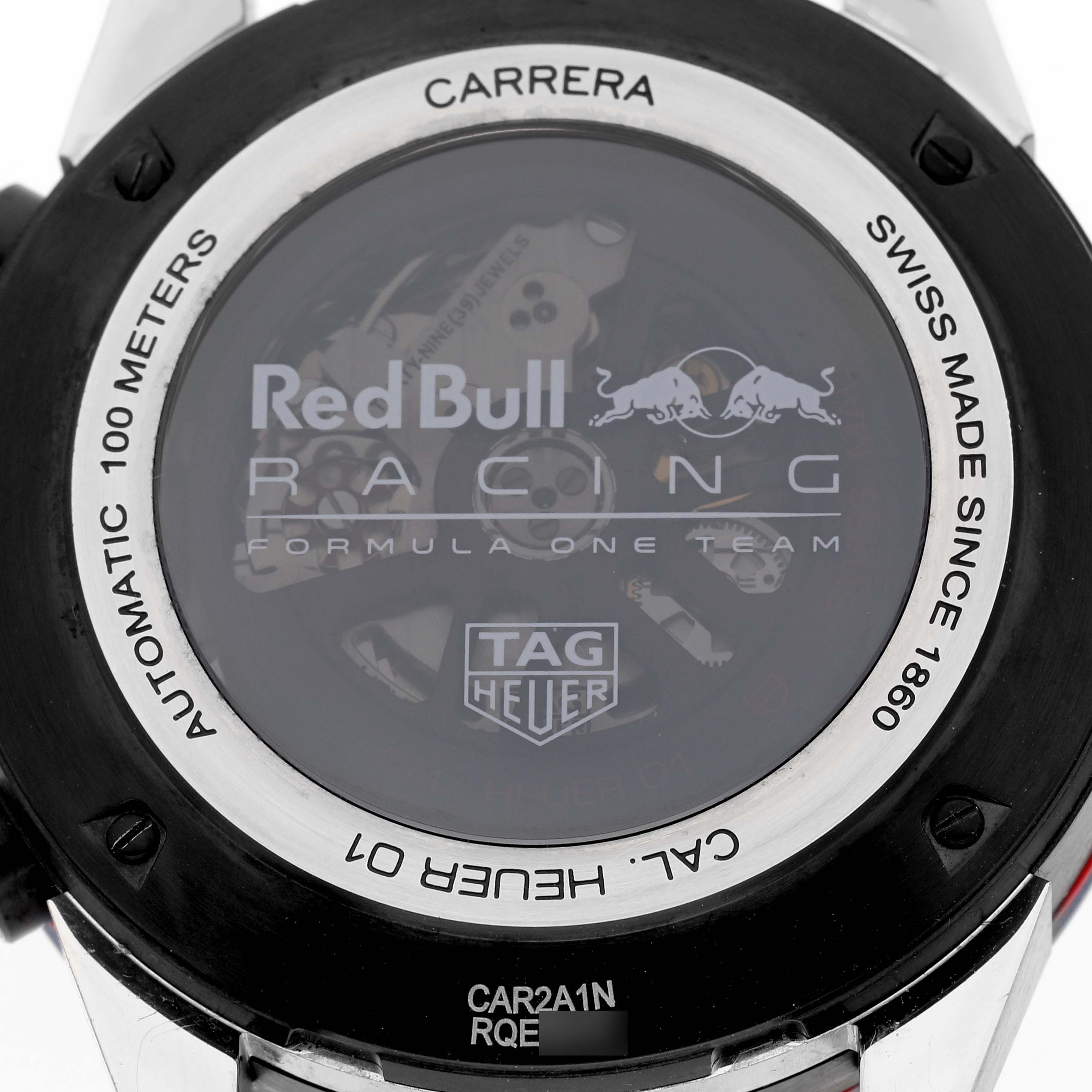 The image shows the back of a Tag Heuer Carrera CAR2A1N.FT6100 Men's Stainless Steel Blue Dial CAR2A1N.FT6100 Men's Stainless Steel Blue Dial watch featuring the Red Bull Racing logo and visible movement.