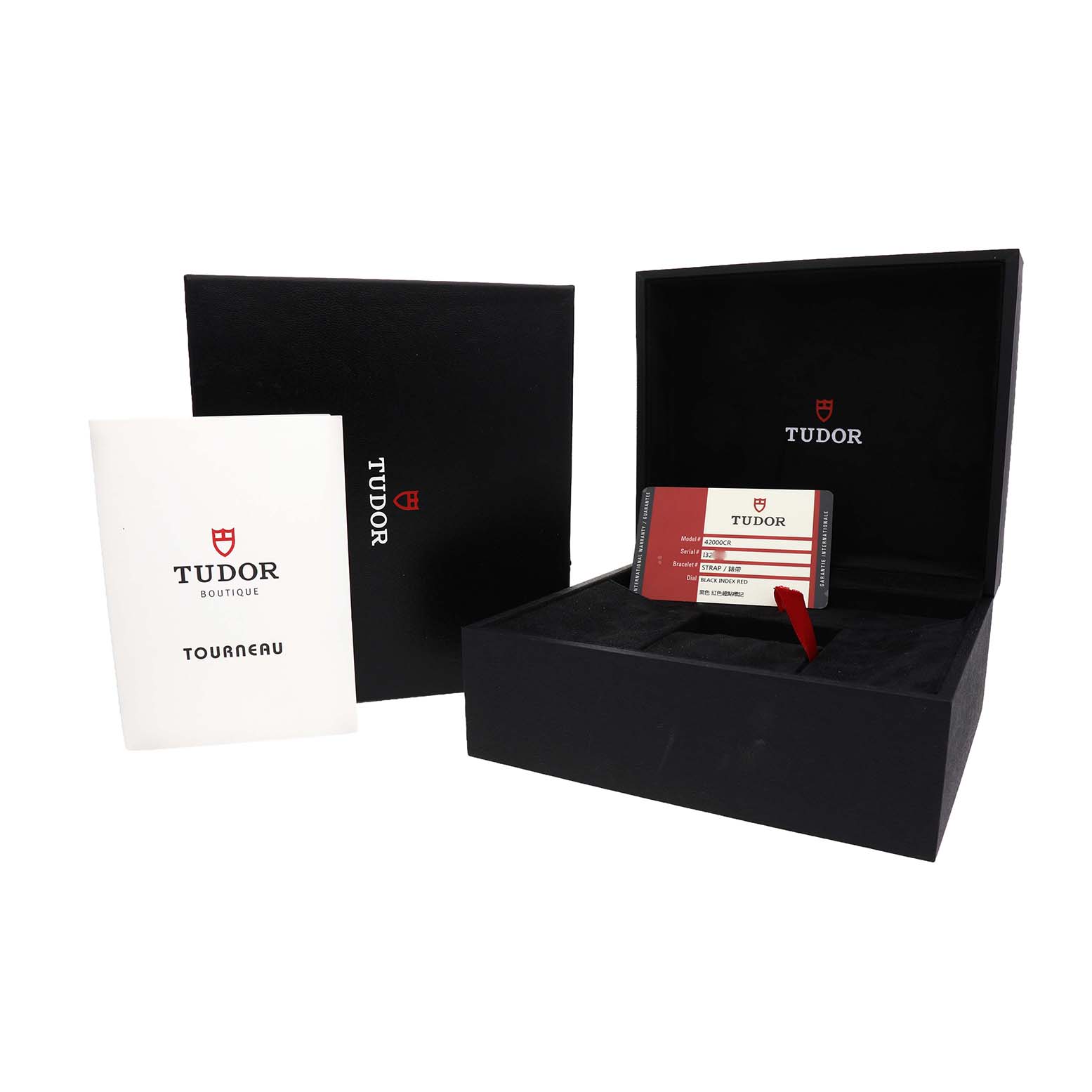 The image shows the Tudor Fastrider 42000CR Men's Ceramic Black Dial's open box, warranty card, and booklet from a front angle.