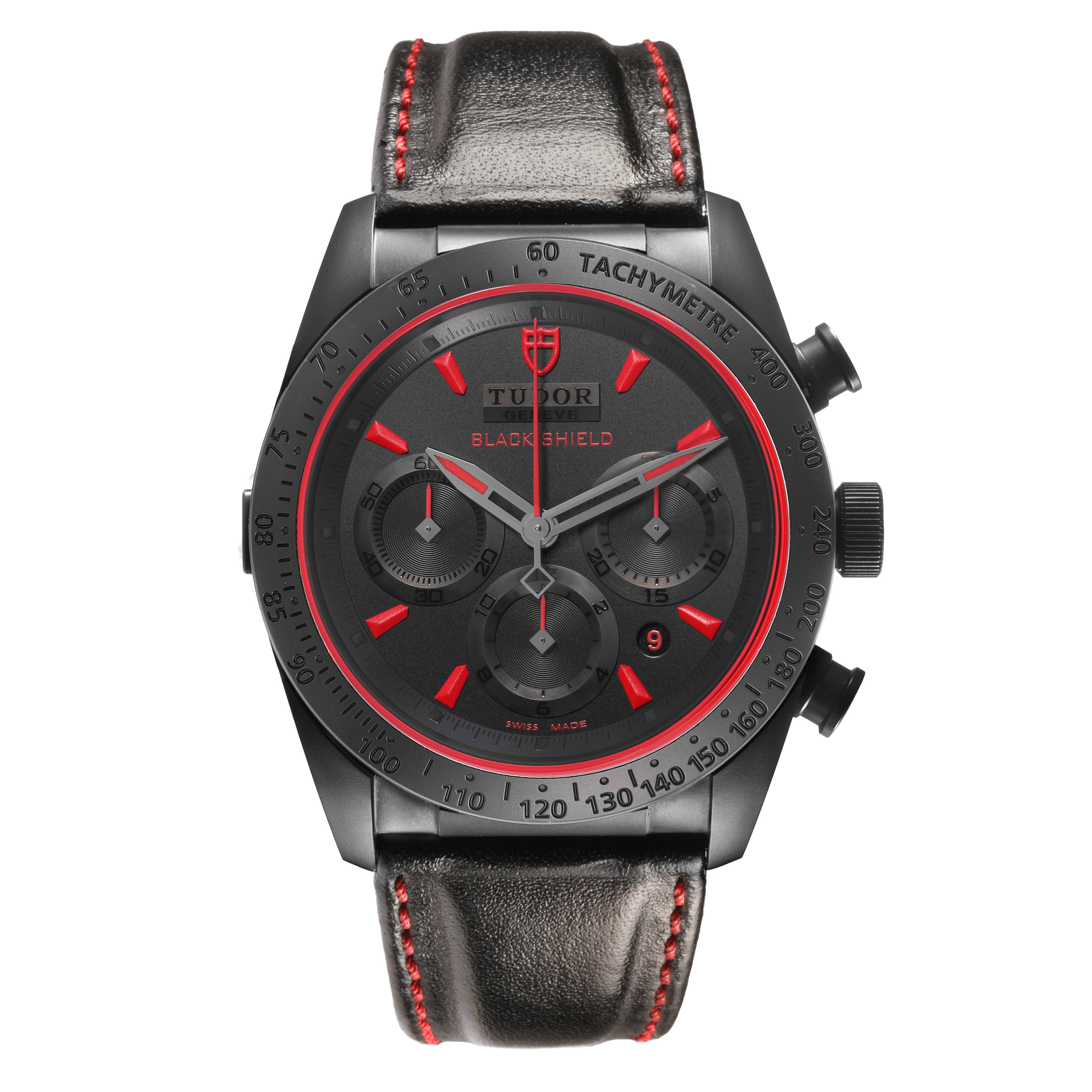 The Tudor Fastrider 42000CR Men's Ceramic Black Dial watch is shown from a front angle, highlighting its black case, red accents, tachymeter bezel, and leather strap.