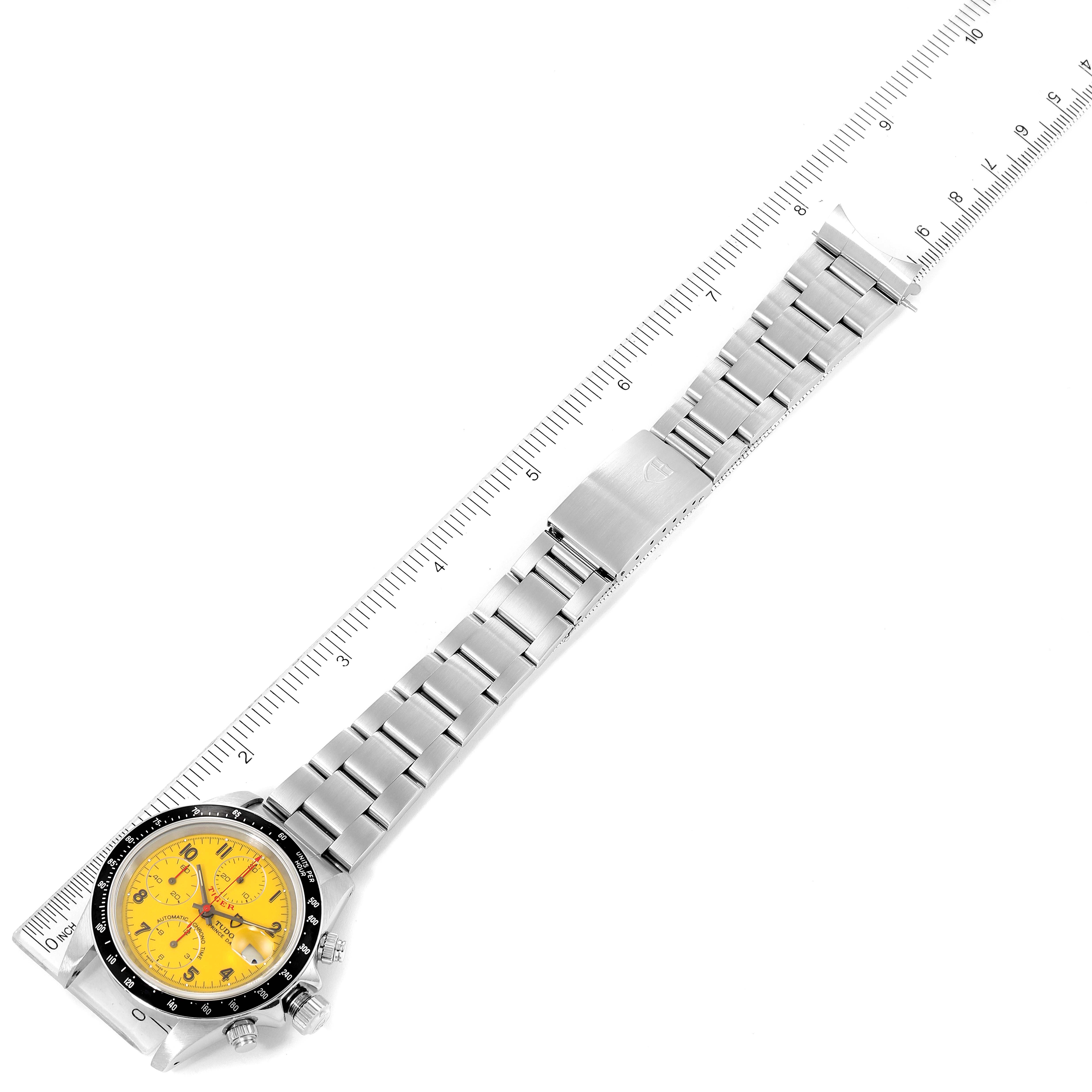 This image shows the Tudor Tiger 79260 Men's Stainless Steel Yellow Dial 79260 Men's Stainless Steel Yellow Dial model watch's entire band and face laid out flat, next to a ruler for scale.