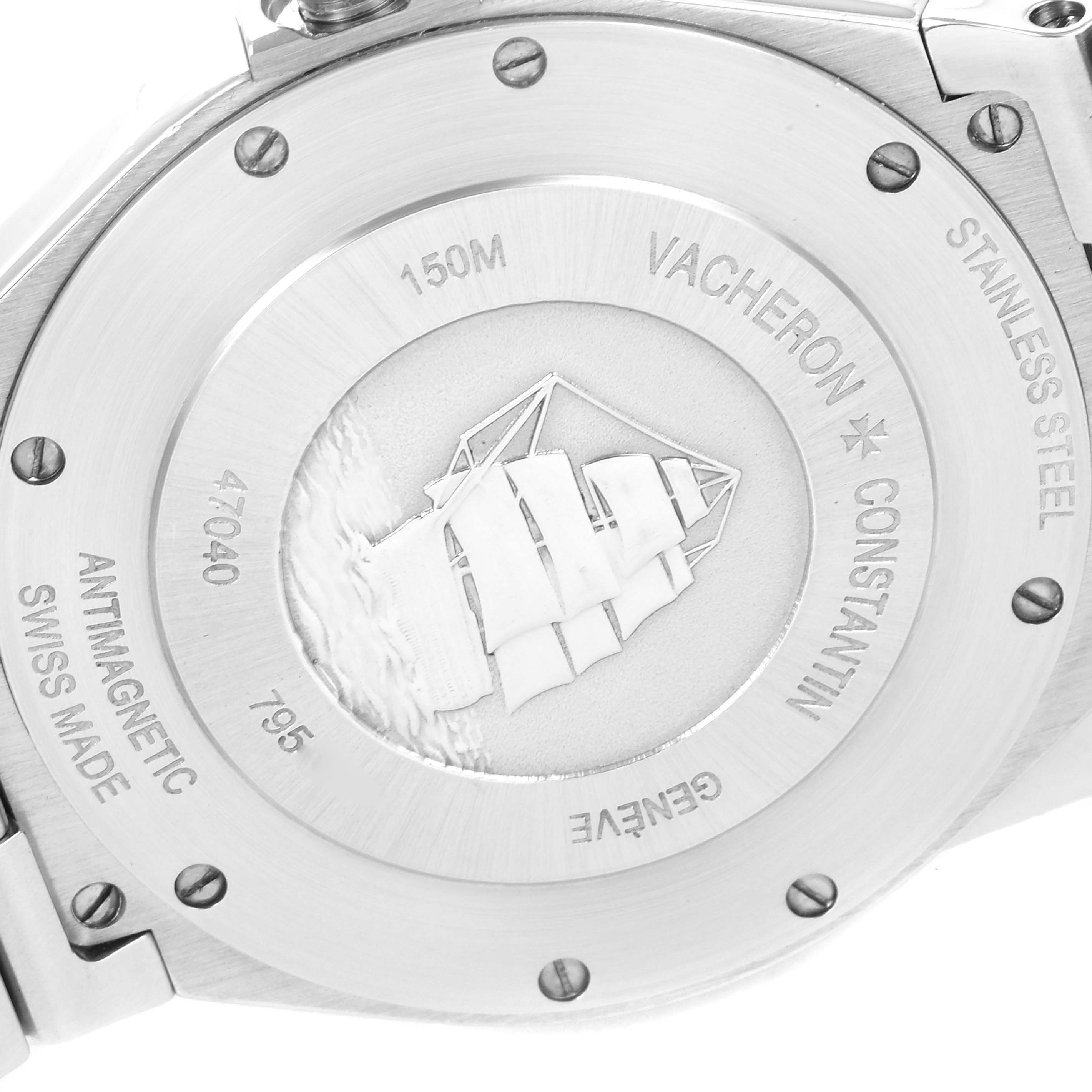 The image shows the back of a Vacheron Constantin Overseas 47040B01A-9093 Men's Stainless Steel Silver Dial 47040B01A-9093 Men's Stainless Steel Silver Dial watch, displaying engravings and a sailing ship motif.