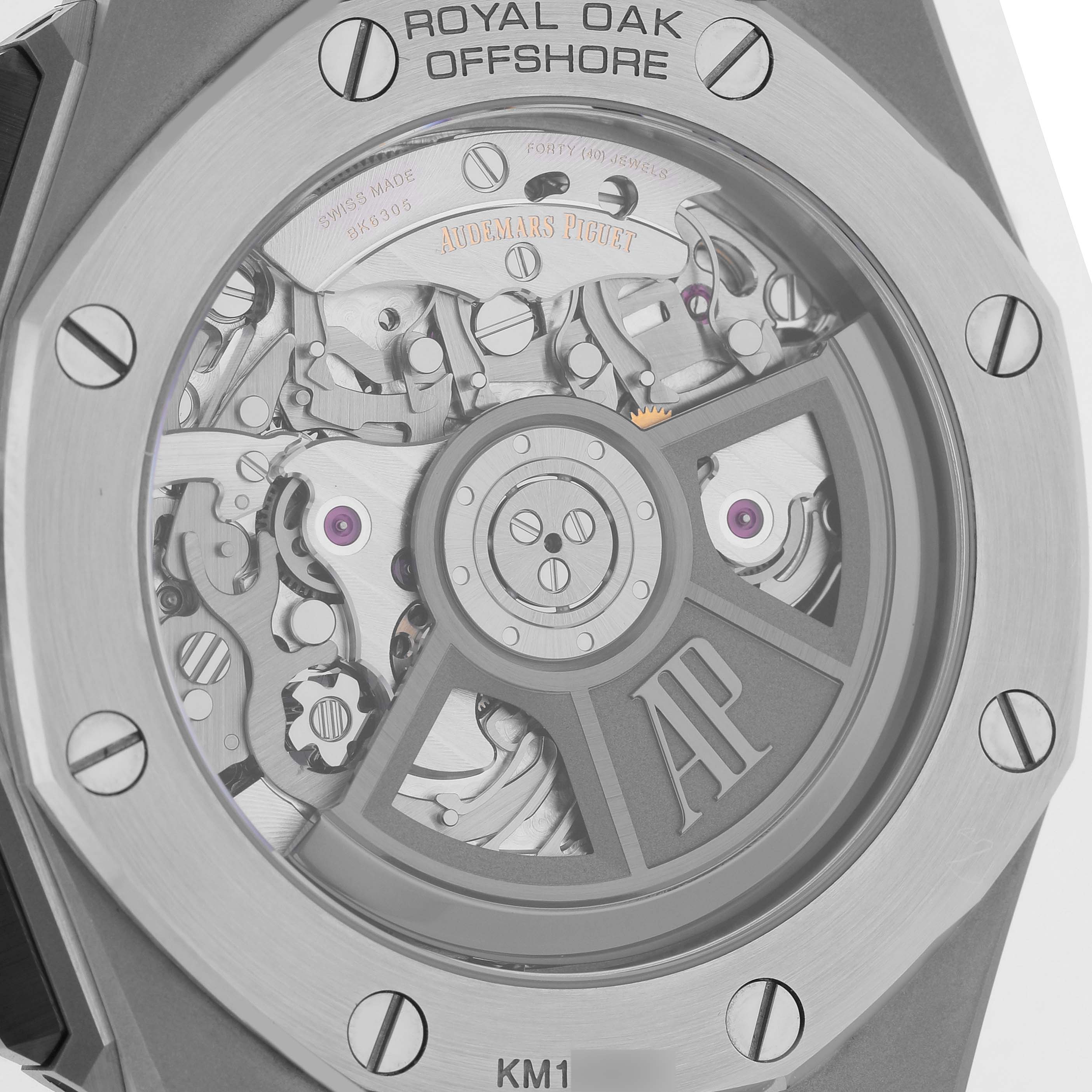 The image shows the back of an Audemars Piguet Royal Oak Offshore 26420SO.OO.A600CA.01 Men's Stainless Steel Brown Dial watch, highlighting its visible movement and rotor.