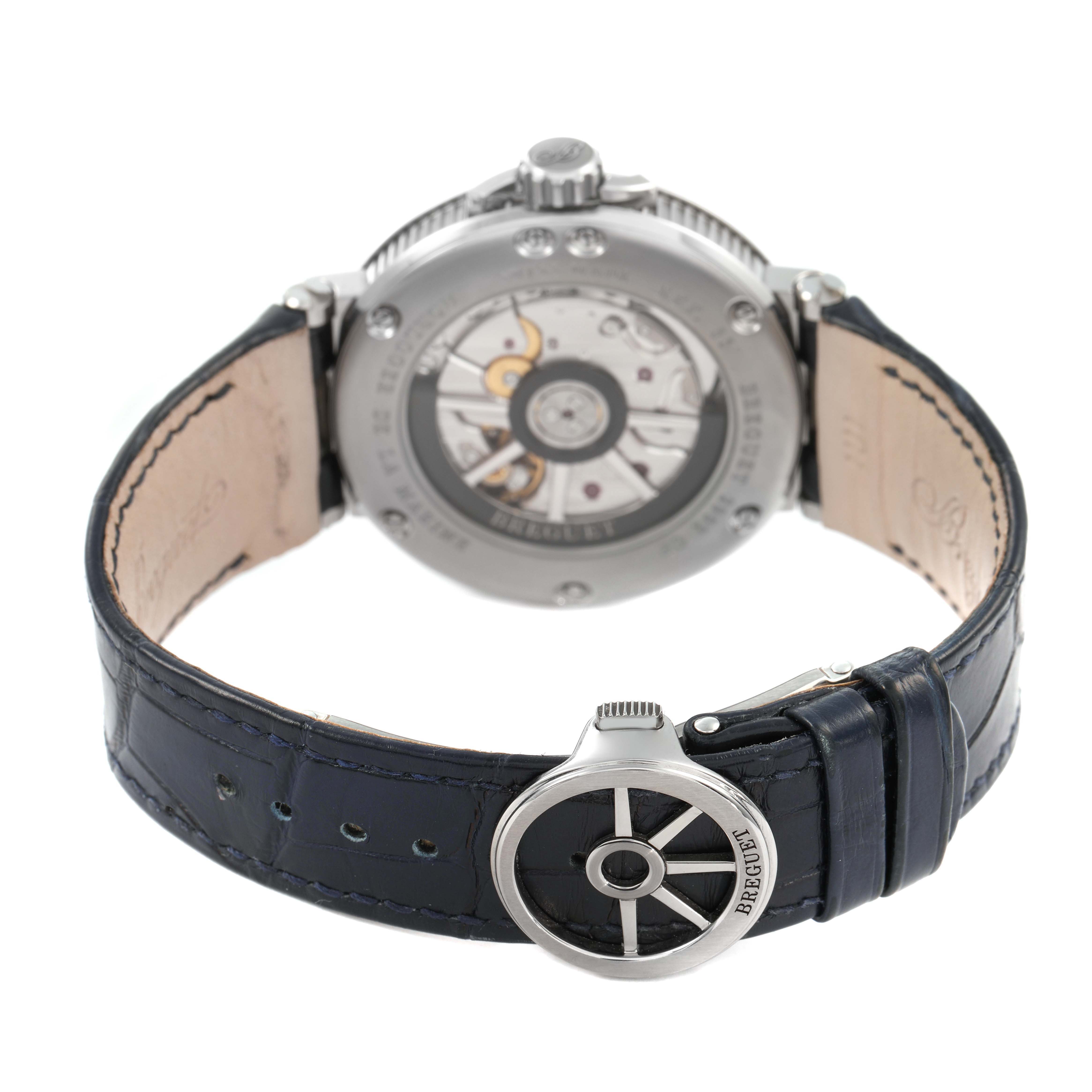 The image shows the back view of the Breguet Marine 5517TI/Y1/TZ0 Men's Titanium Blue Dial watch, highlighting its open case back and clasp with brand engraving.