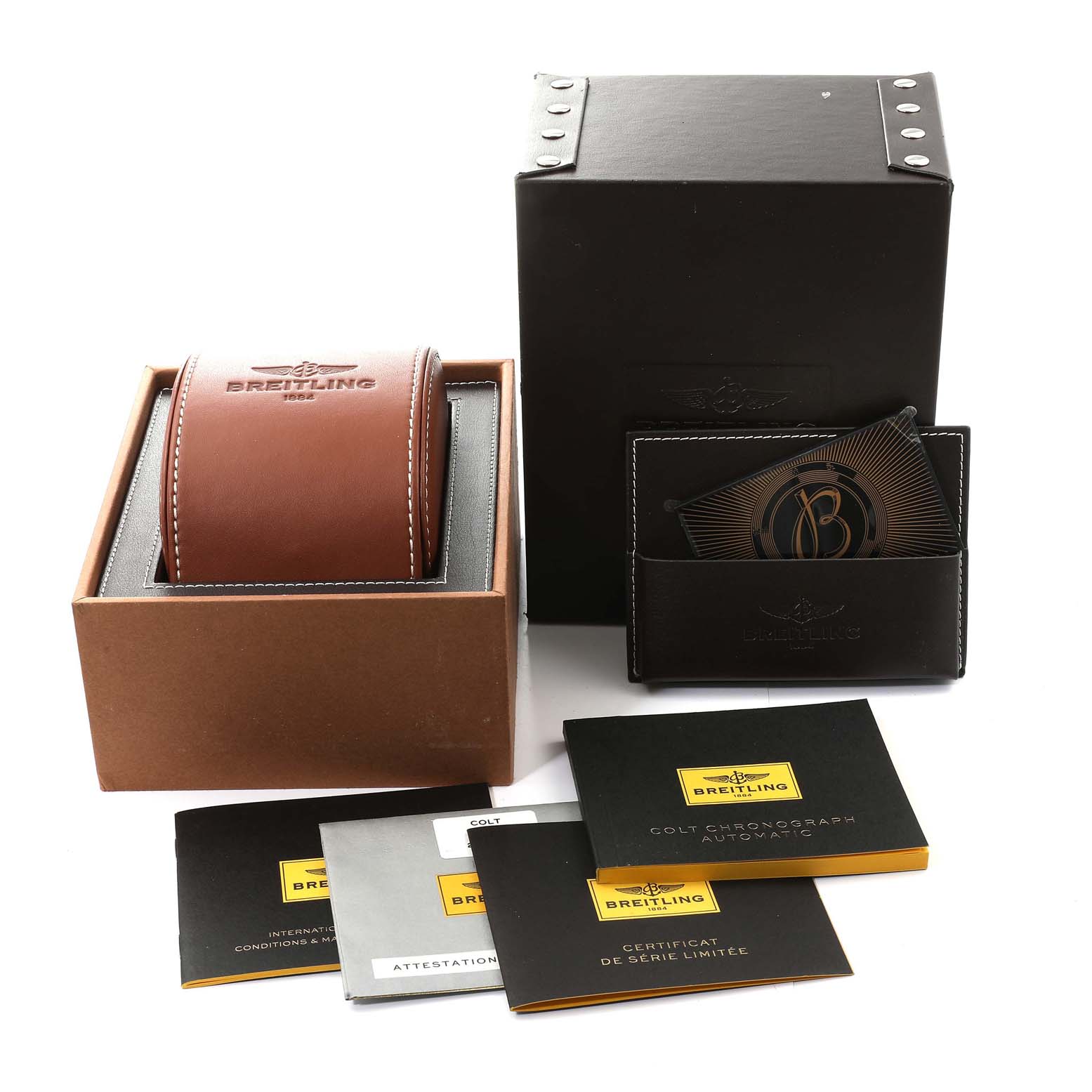 The image shows the packaging and documents for a Breitling Colt A13388 Men's Stainless Steel Black Dial A13388 Men's Stainless Steel Black Dial watch, including a box, leather travel case, and various manuals.