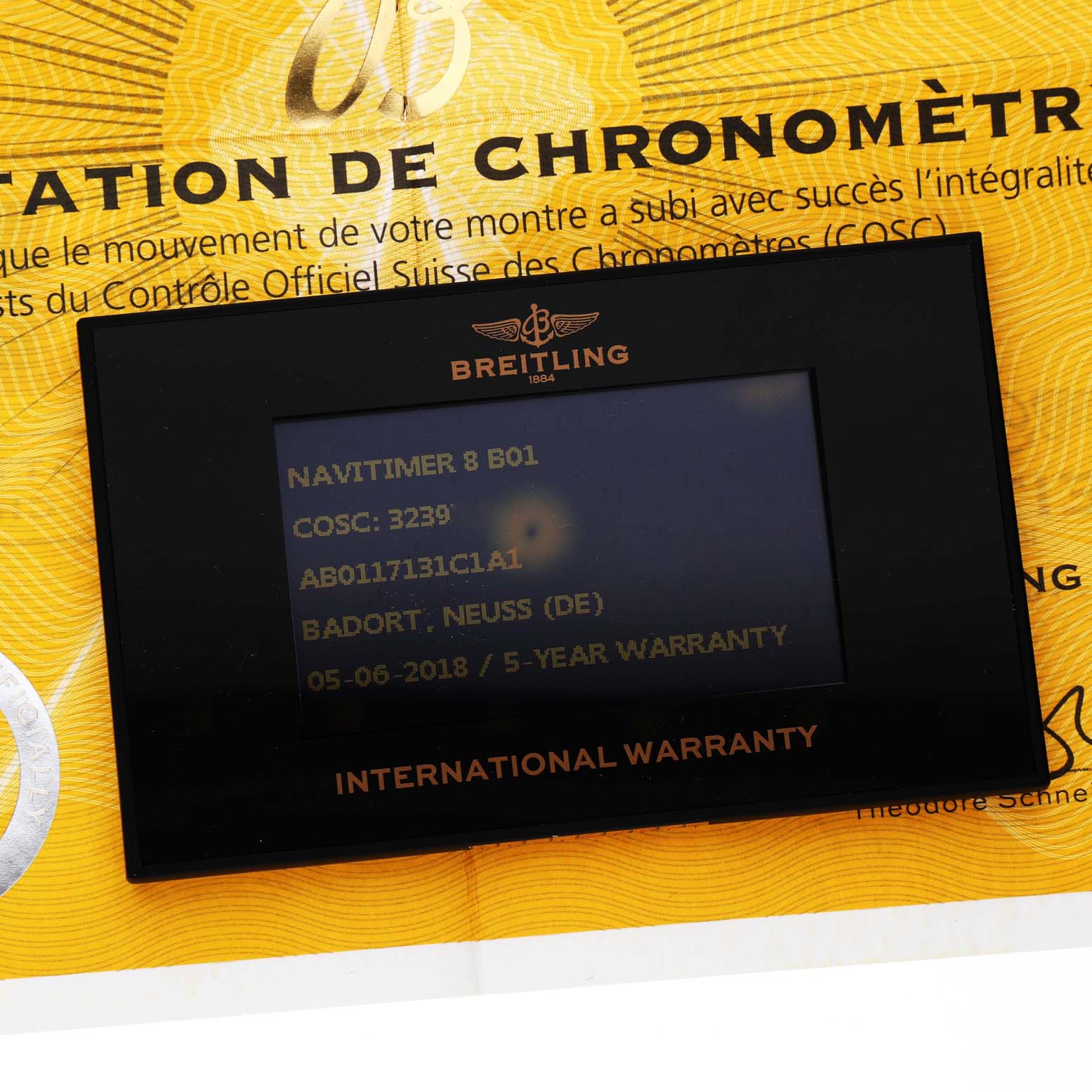 This image shows the warranty card and certification paperwork for a Breitling Navitimer 8 B01.