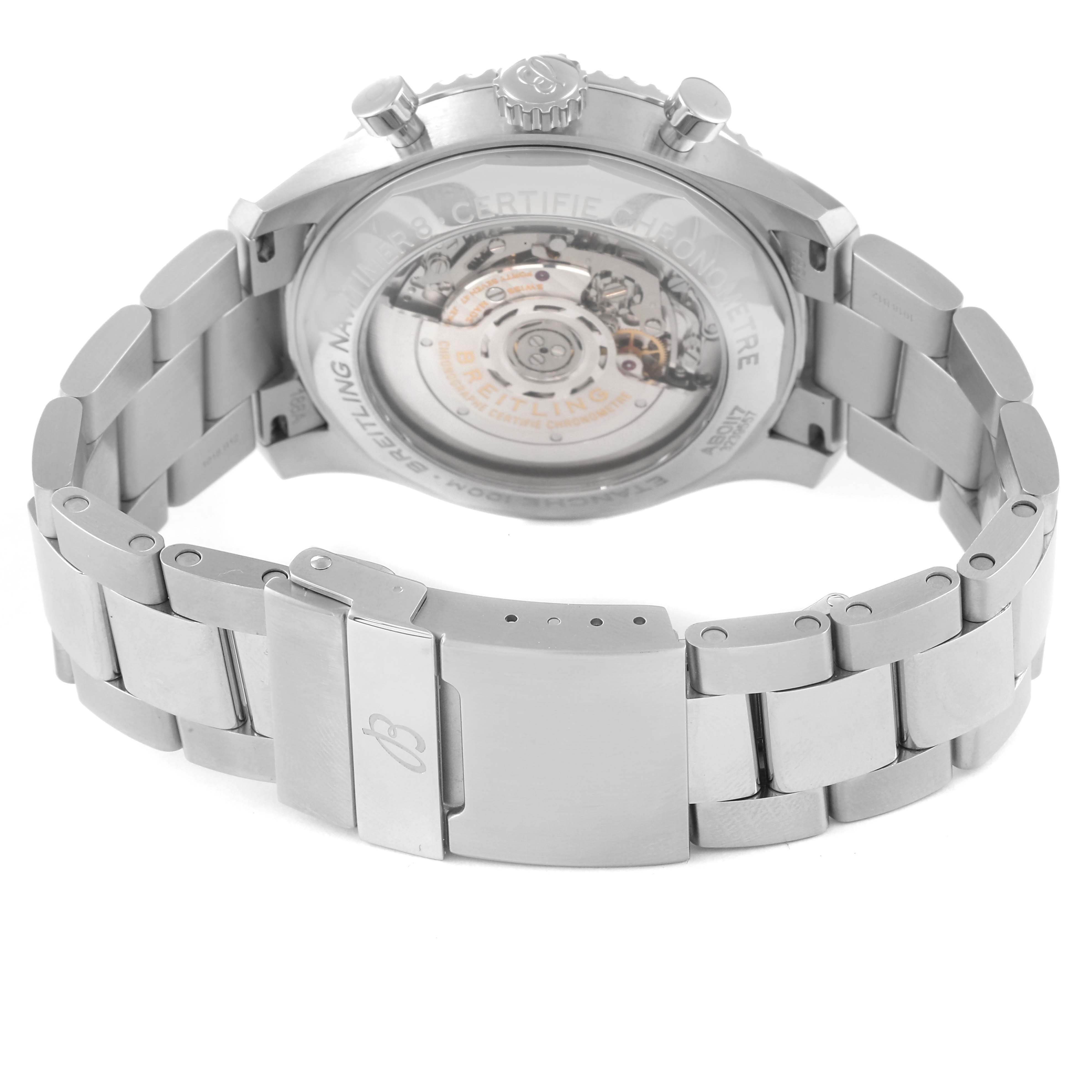 The image shows the rear view of the Breitling Navitimer watch, highlighting the transparent case back and metal bracelet.