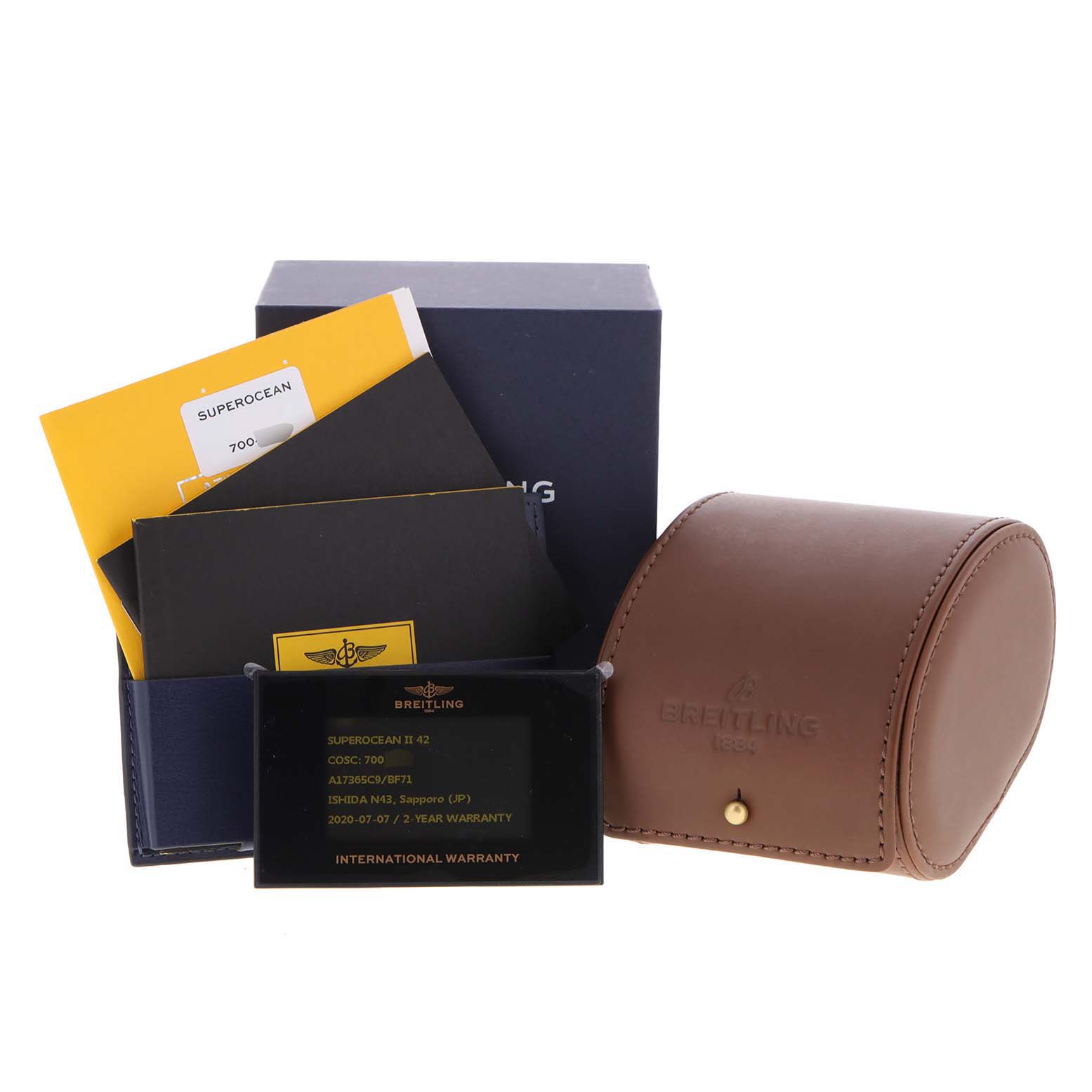 The image shows Breitling Superocean A17365 Men's Stainless Steel Black Dial A17365 Men's Stainless Steel Black Dial packaging, including the warranty card, manual booklets, and watch case from a frontal angle.