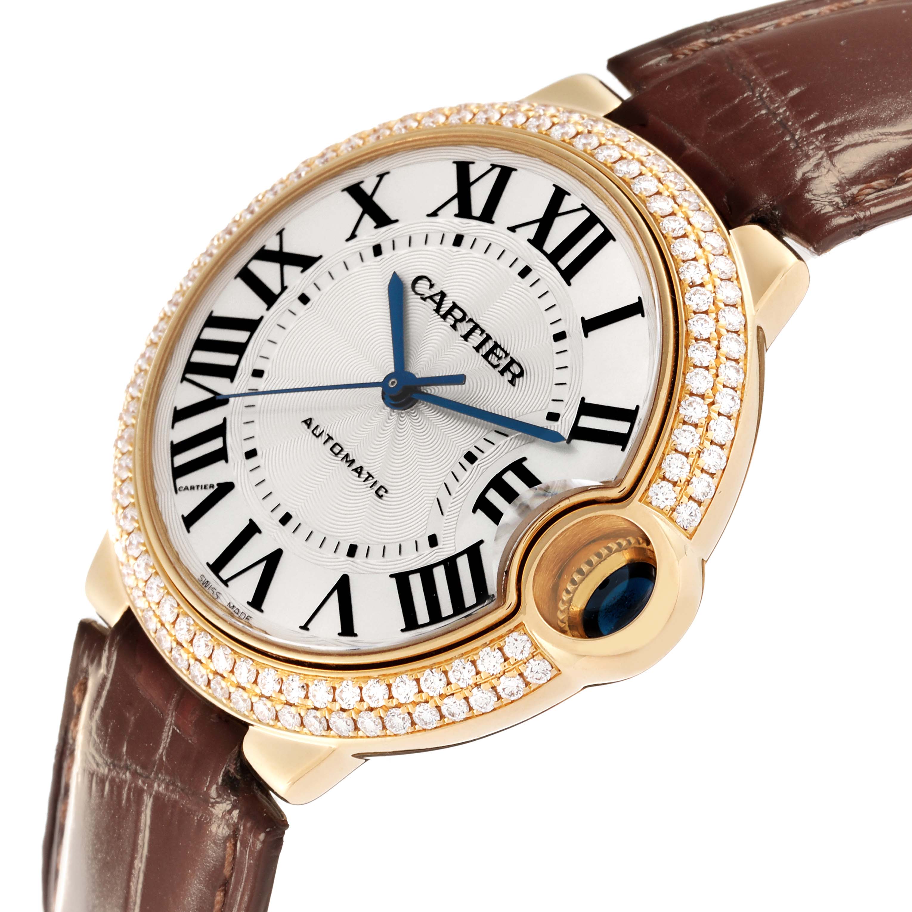 The image shows a Cartier Ballon Bleu WE900451 Men's Yellow Gold Silver Dial WE900451 Men's Yellow Gold Silver Dial watch from an angled view, highlighting its dial, diamond bezel, and leather strap.