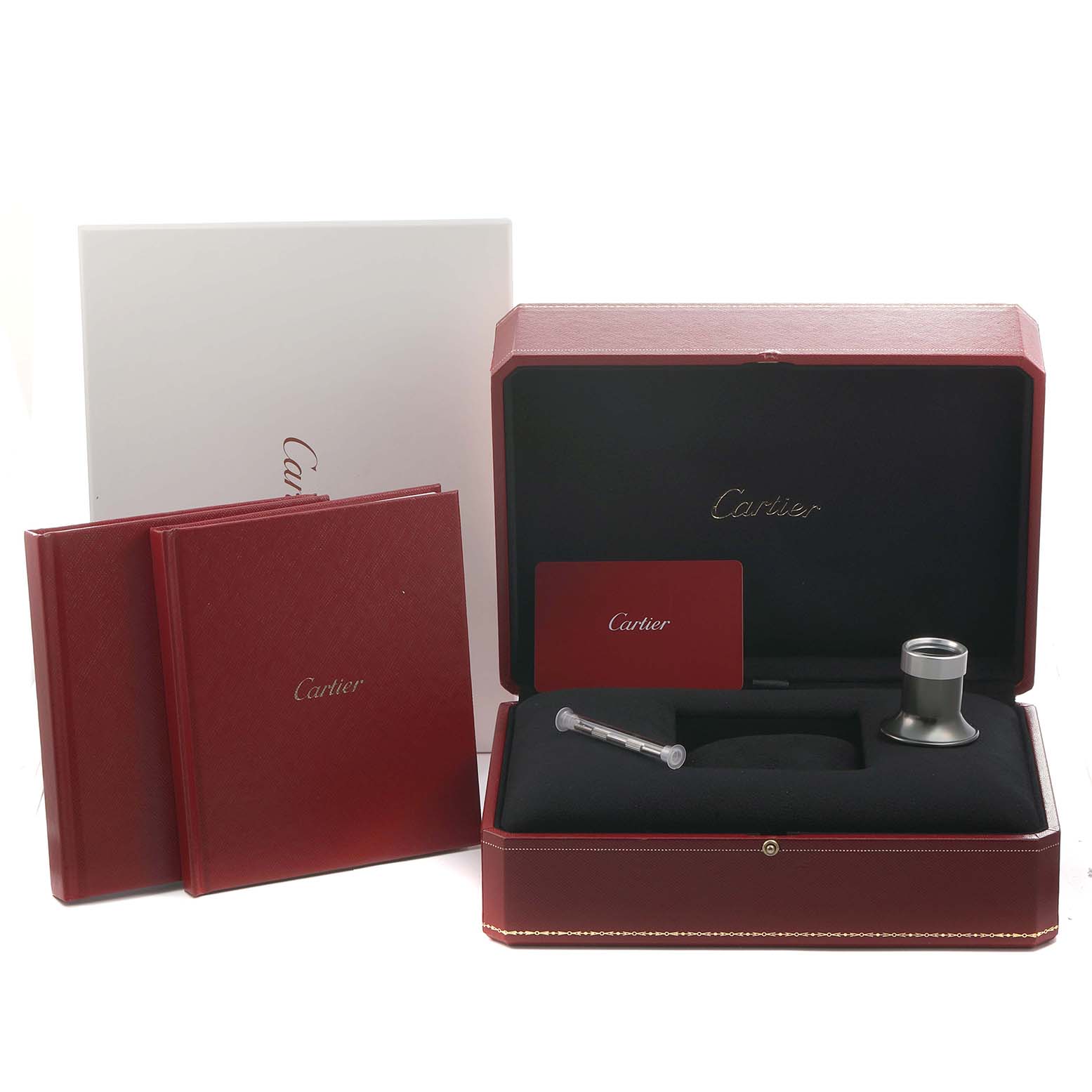 The image shows a Cartier Pasha WHPA0017 Men's Stainless Steel Transparent Dial watch box set with red packaging, manuals, a lens, and a tool at a front angle.