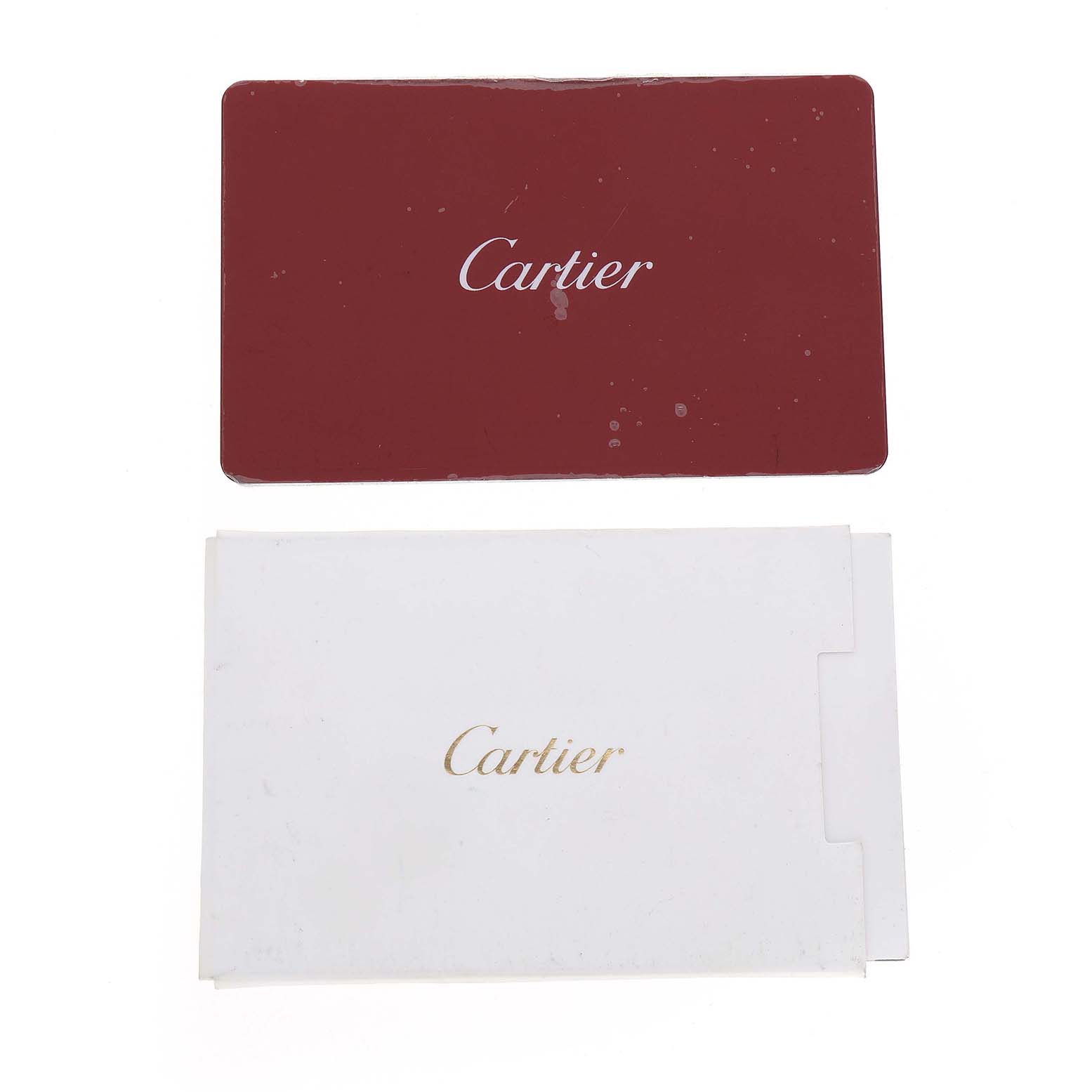 The image shows a red Cartier card and a white envelope, likely accessories for the Cartier Ronde WSRN0031 Men's Stainless Steel Silver Dial model watch.
