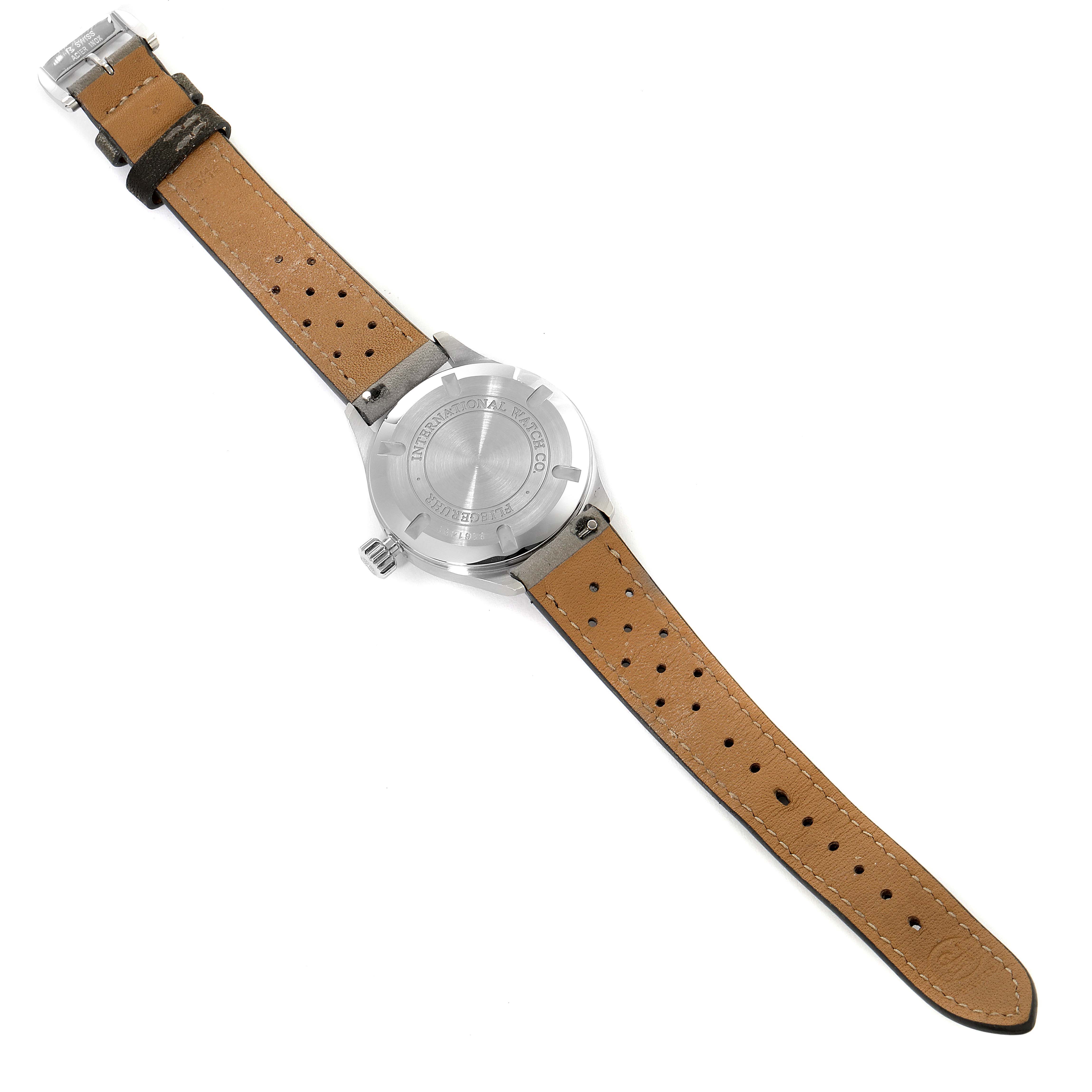 The image shows the back view of an IWC Pilot IW325601 Men's Stainless Steel Black Dial IW325601 Men's Stainless Steel Black Dial model watch, displaying its case back and leather strap.