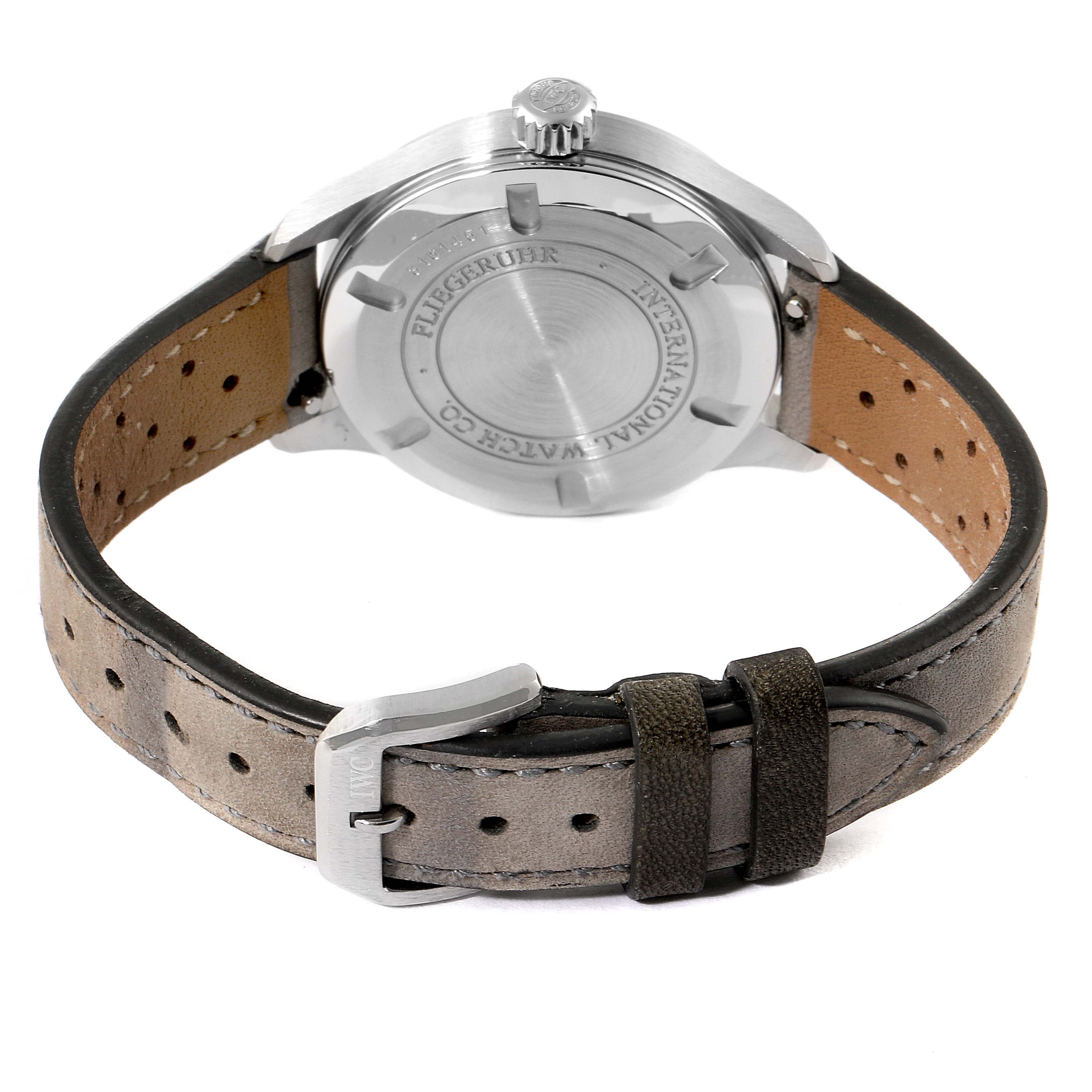 The image shows the back view of an IWC Pilot IW325601 Men's Stainless Steel Black Dial IW325601 Men's Stainless Steel Black Dial model, displaying the case back, crown, and leather strap with a buckle.