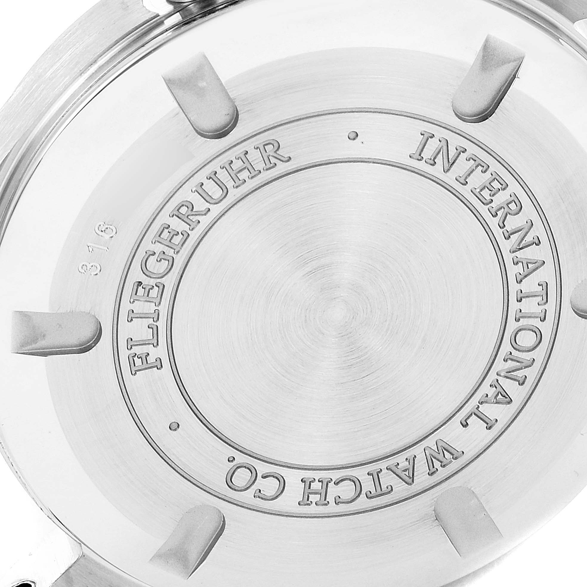 This image shows the back case of the IWC Pilot IW325601 Men's Stainless Steel Black Dial IW325601 Men's Stainless Steel Black Dial model watch, highlighting the engraved branding and screws.