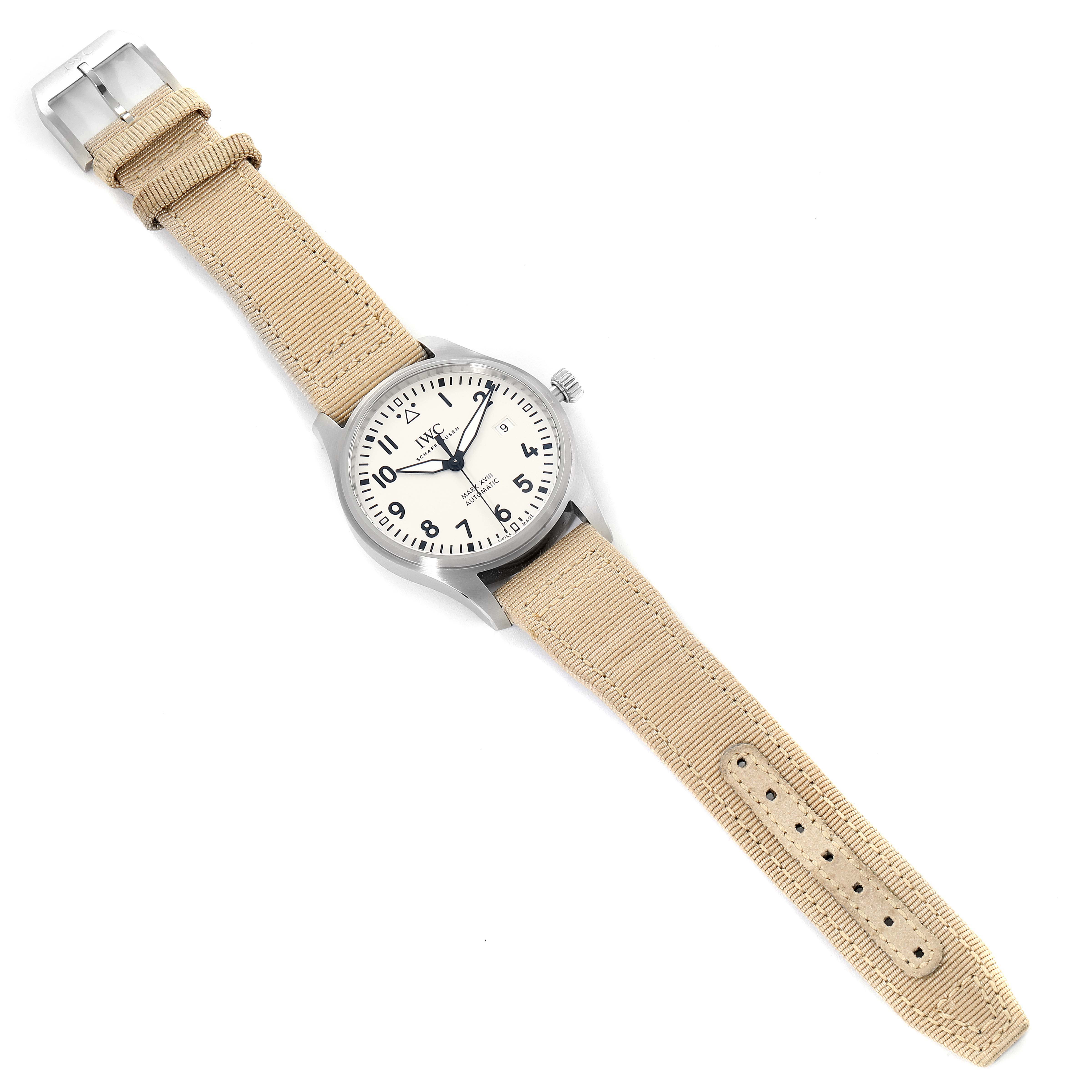 The IWC Pilot IW327017 Men's Stainless Steel Silver Dial IW327017 Men's Stainless Steel Silver Dial watch is shown from a top-down angle, displaying its face, bezel, crown, and beige strap.