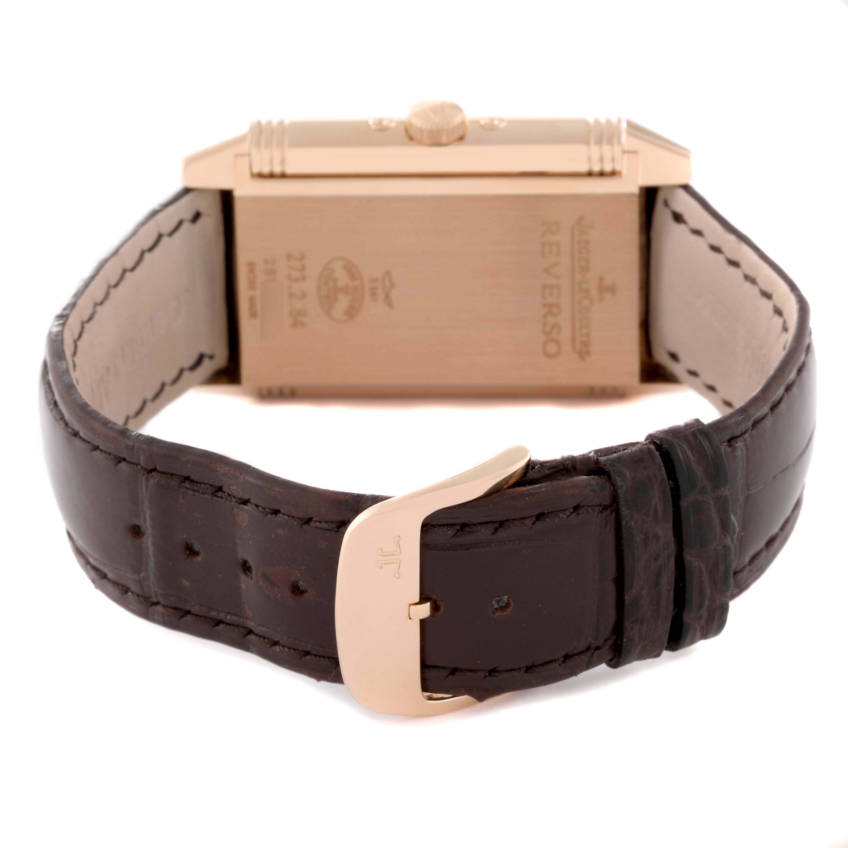 The image shows the back view of a Jaeger LeCoultre Reverso Q3752520 Men's Rose Gold Silver Dial Q3752520 Men's Rose Gold Silver Dial watch, highlighting the back case and brown leather strap with a gold buckle.