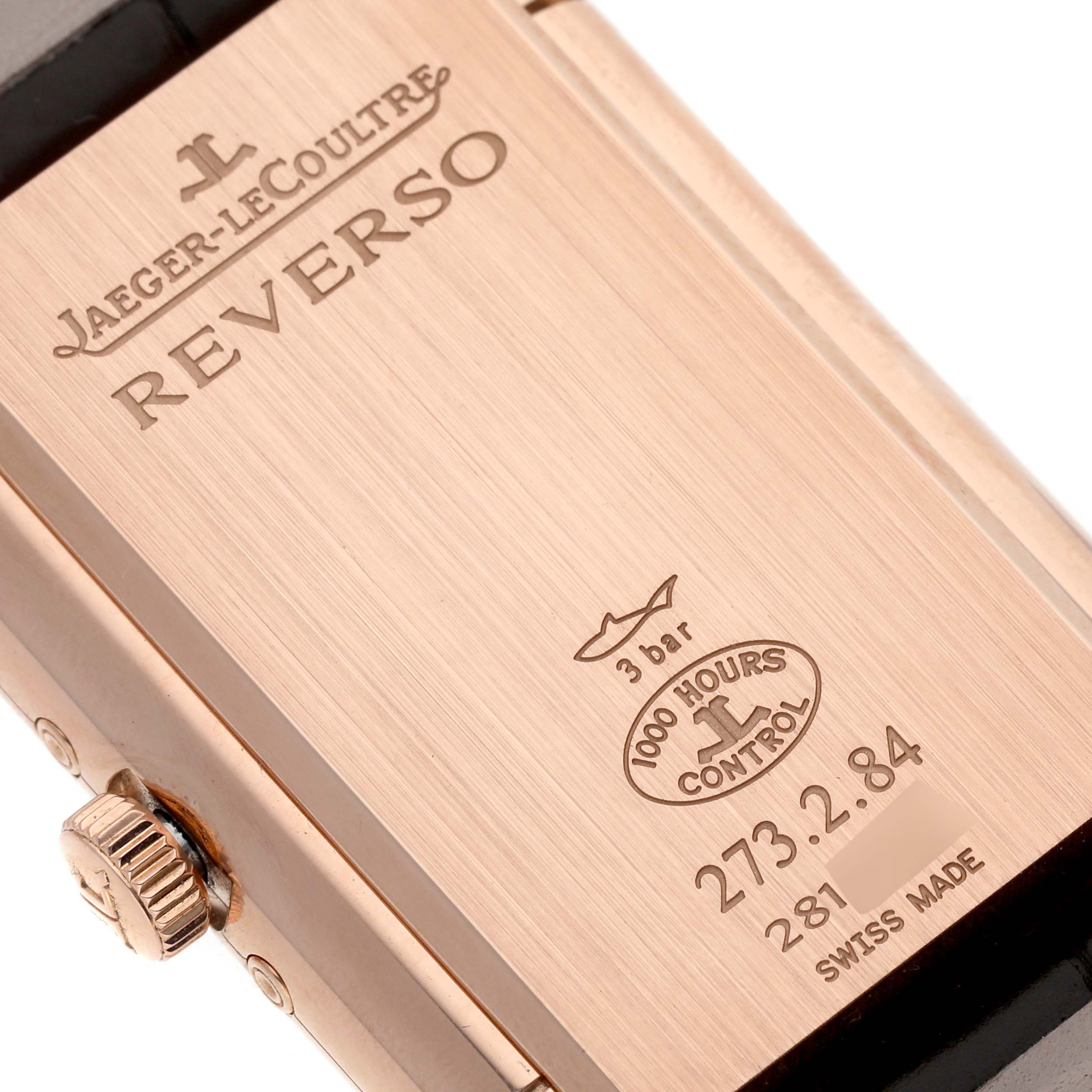 This image shows the back case of a Jaeger-LeCoultre Reverso watch, featuring engravings of the brand and model details.