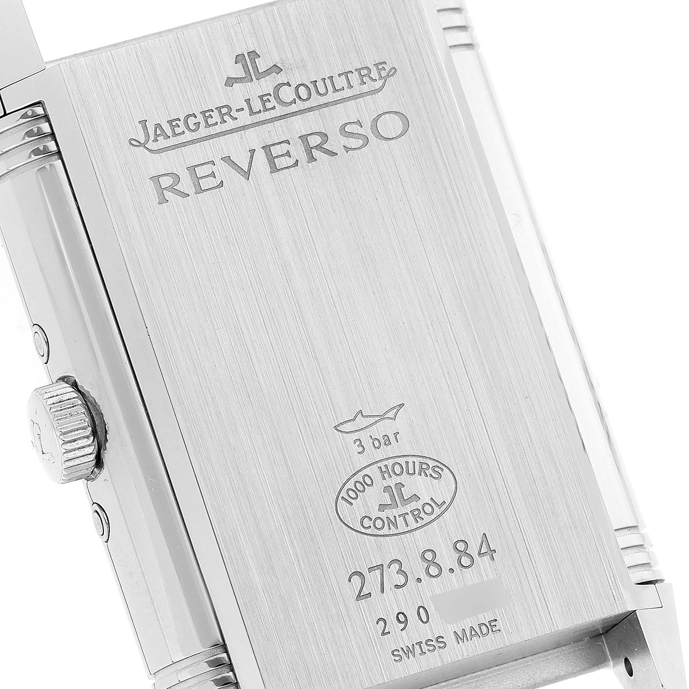 The image shows the back of a Jaeger-LeCoultre Reverso watch, including its engravings and side crown.