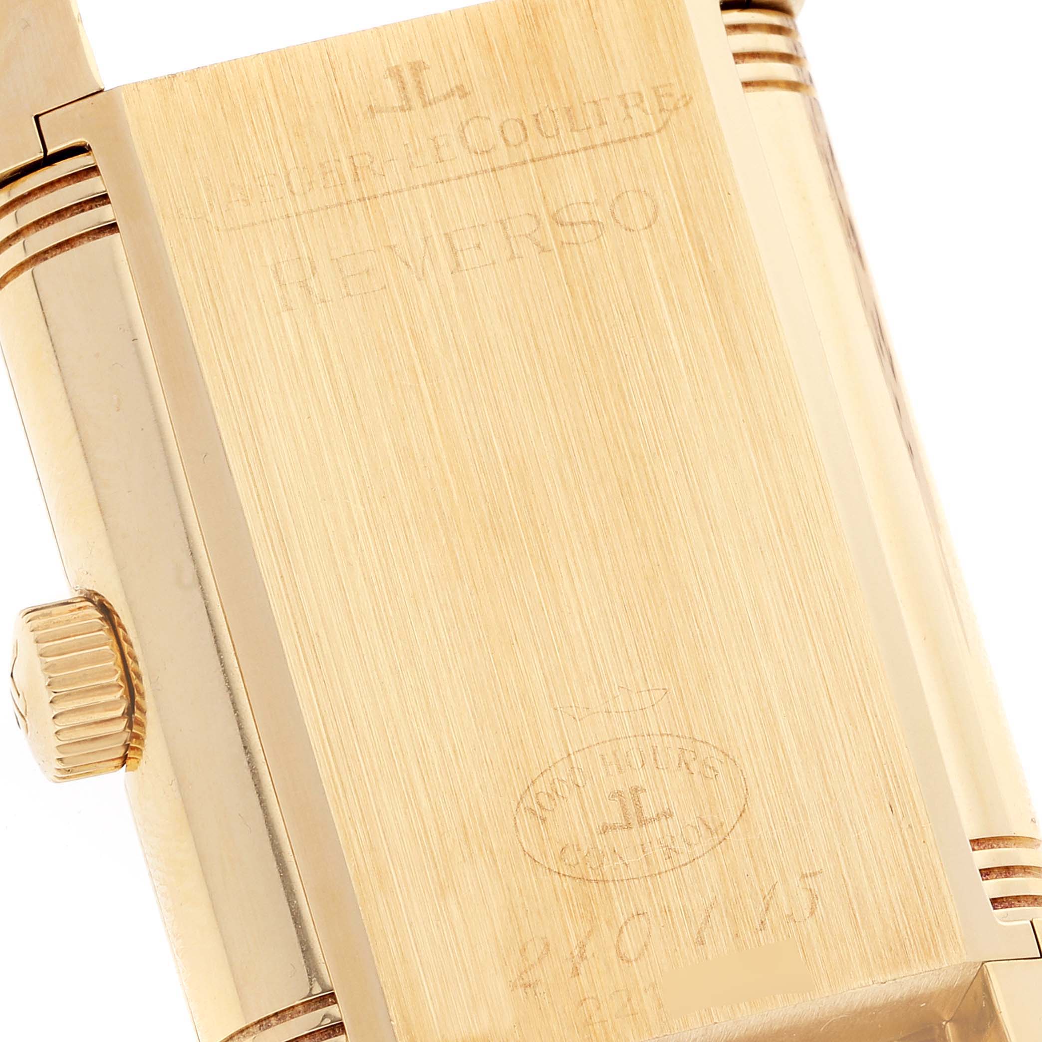 The image shows the reverse side of a Jaeger LeCoultre Reverso Q3001420 Men's Yellow Gold Silver Dial Q3001420 Men's Yellow Gold Silver Dial watch in close-up, highlighting the engraved details.