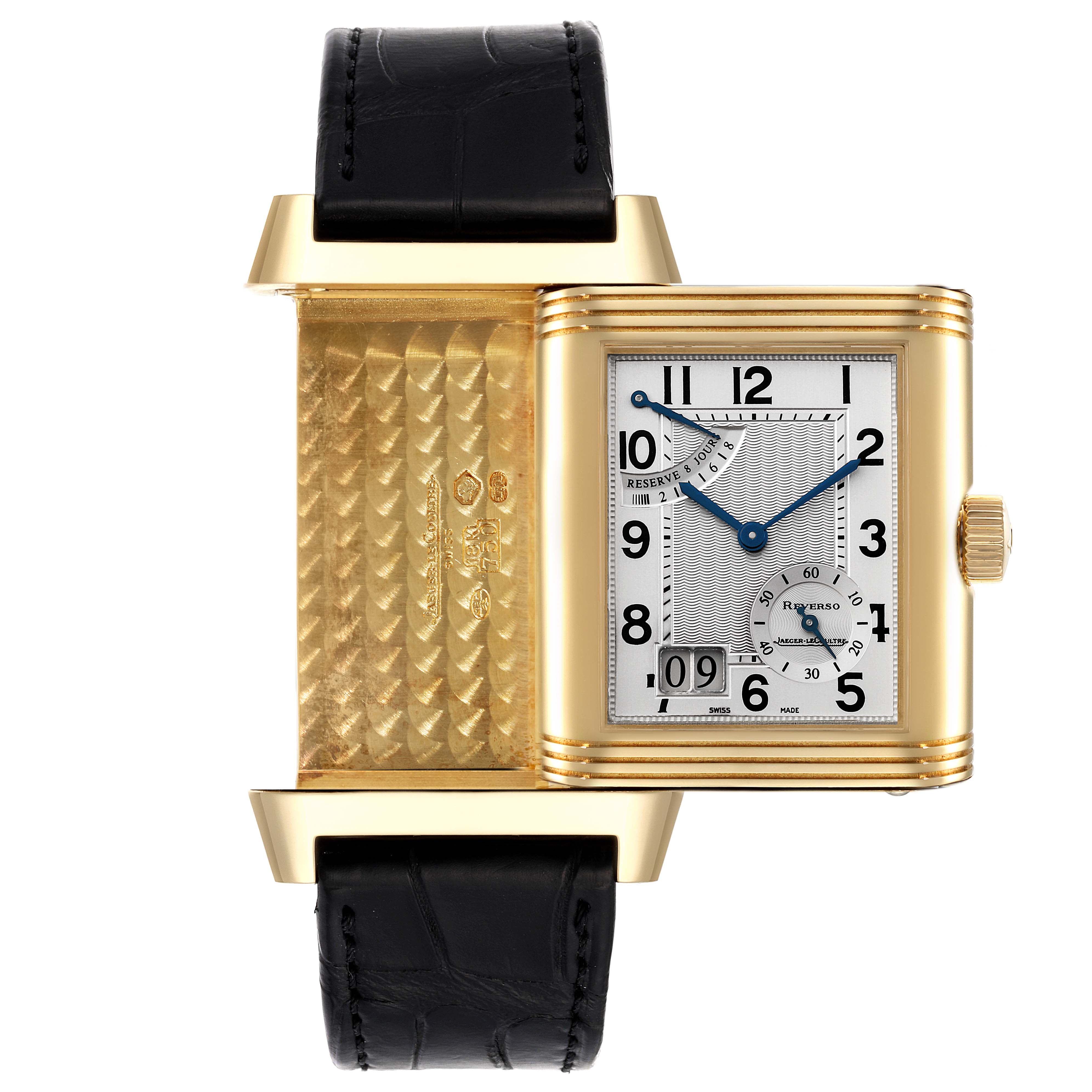 The image shows the Jaeger LeCoultre Reverso Q3001420 Men's Yellow Gold Silver Dial Q3001420 Men's Yellow Gold Silver Dial watch with its case flipped open, revealing the intricate gold interior and the front dial.