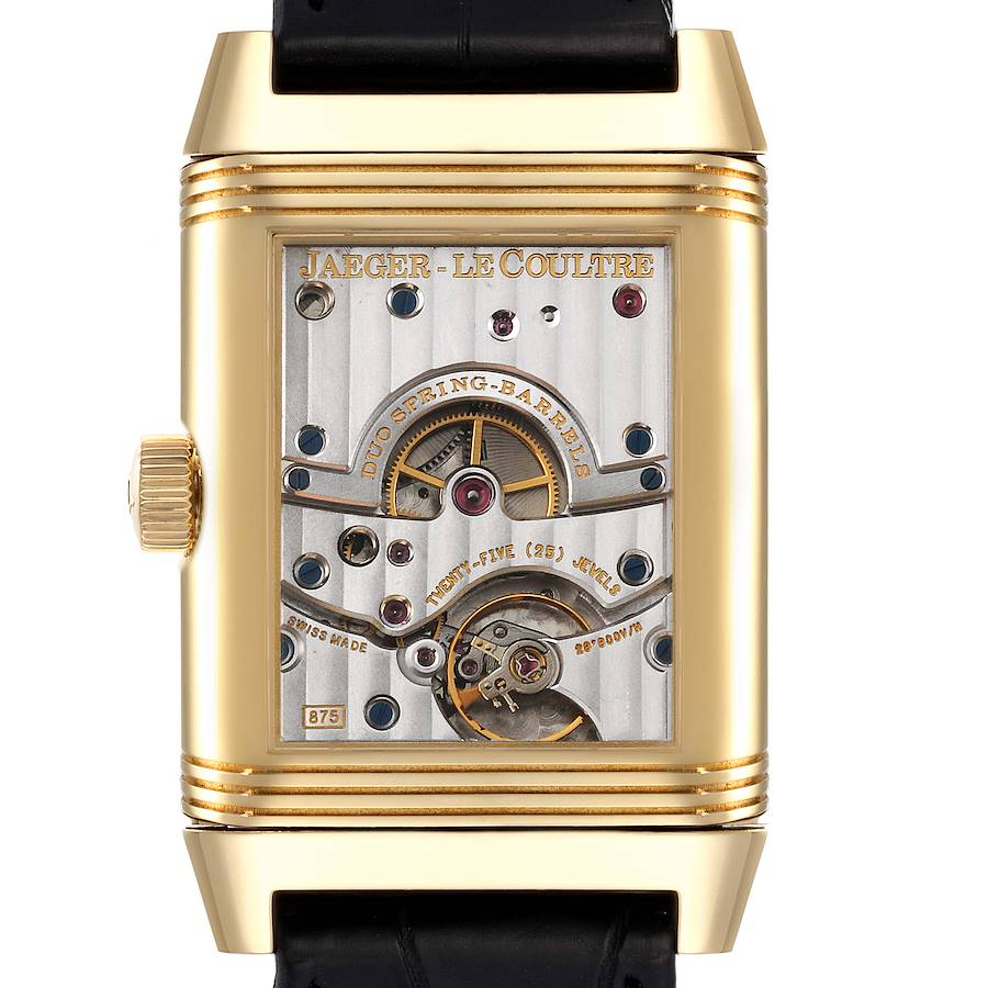 The image shows the back view of a Jaeger LeCoultre Reverso watch, revealing its intricate mechanical movement.