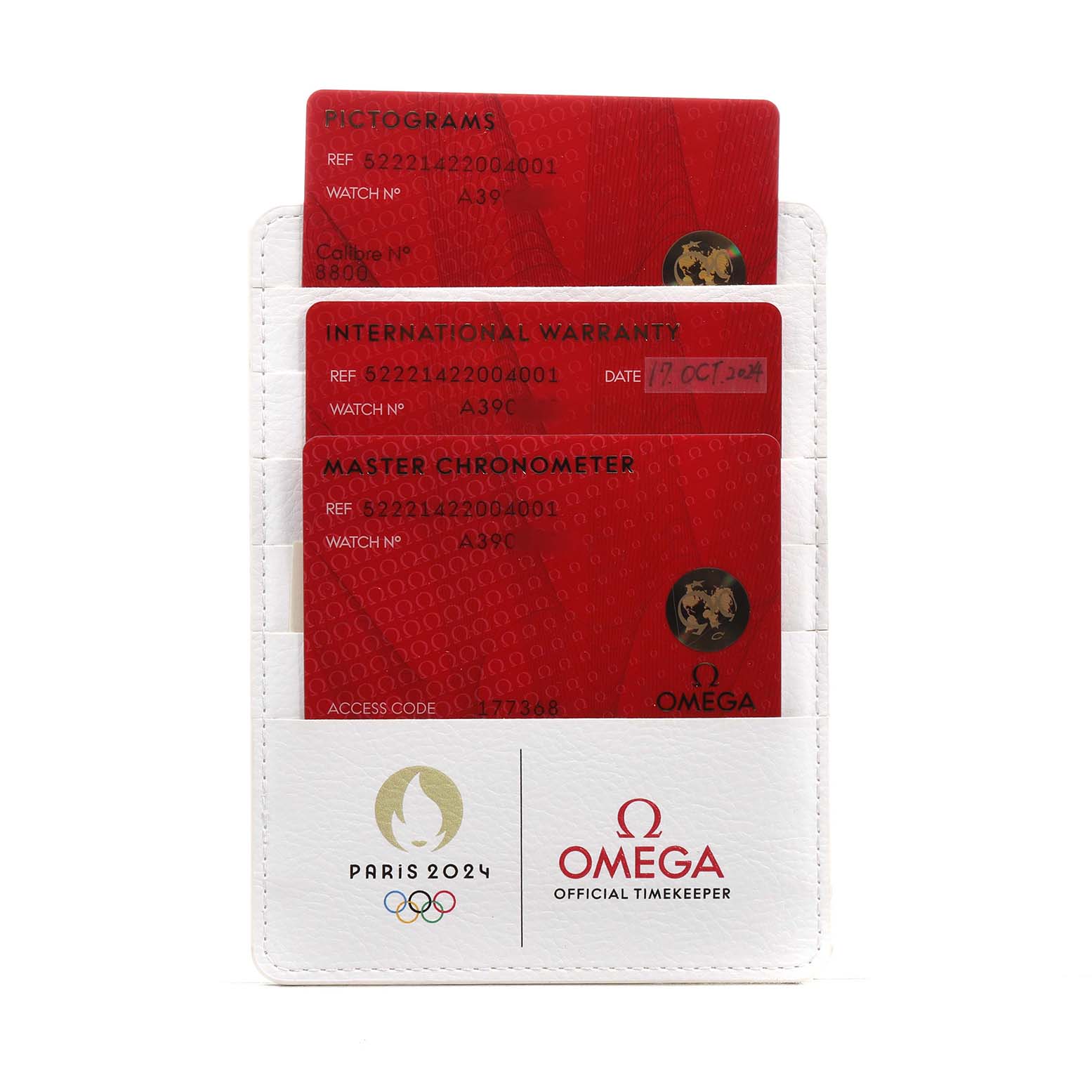 The image shows the warranty and pictogram cards for the Omega Seamaster 522.21.42.20.04.001 Men's Stainless Steel White Dial, placed in a branded case.